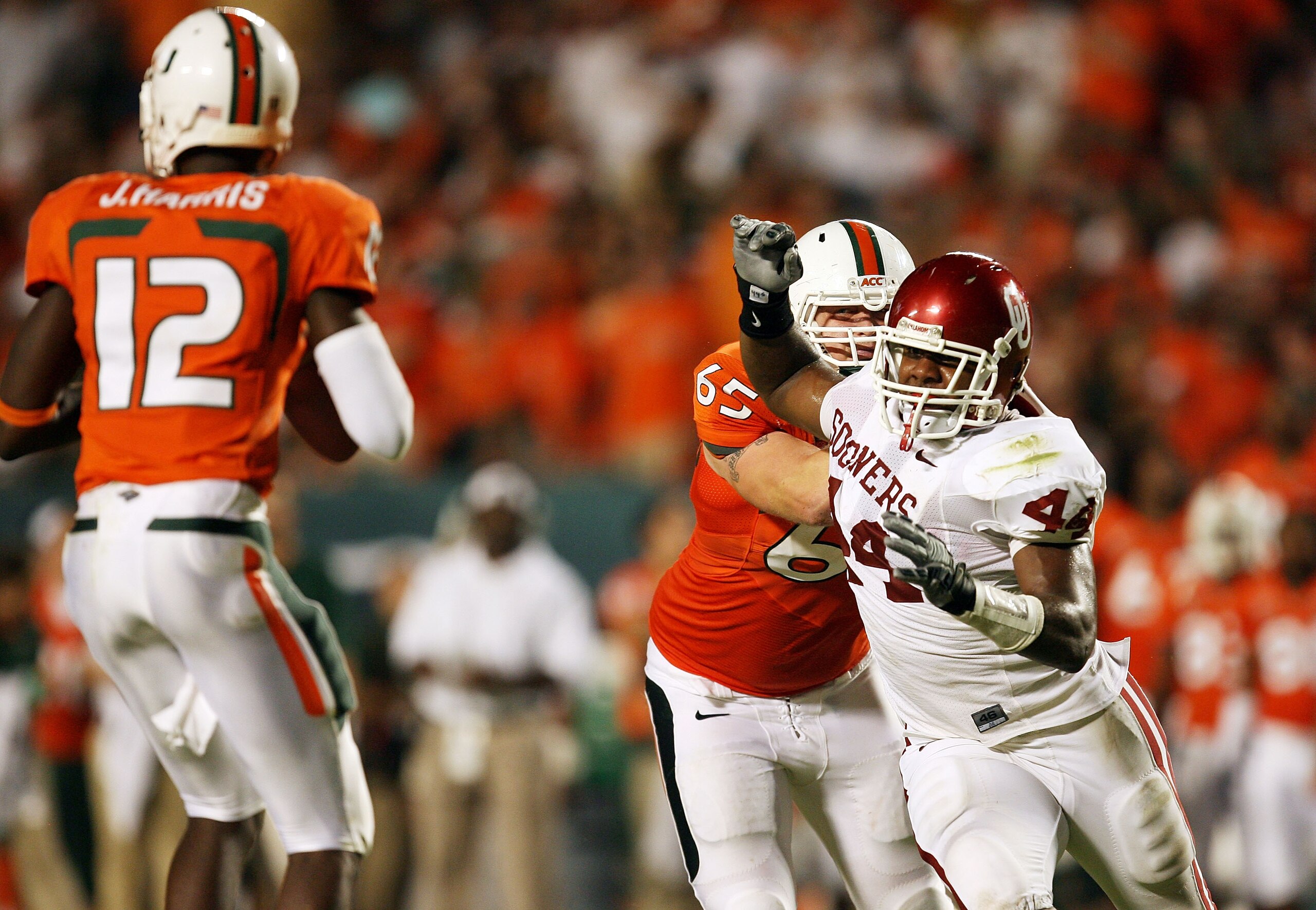 FORT LAUDERDALE, FL - OCTOBER 03: Quarterback Jacory Harris #12 of the Miami Hurricanes drops back to pass as defensive end Jeremy Beal #44 of the Oklahoma Sooners gets past offensive lineman Matt Pipho #65 at Land Shark Stadium on October 3, 2009 in Fort