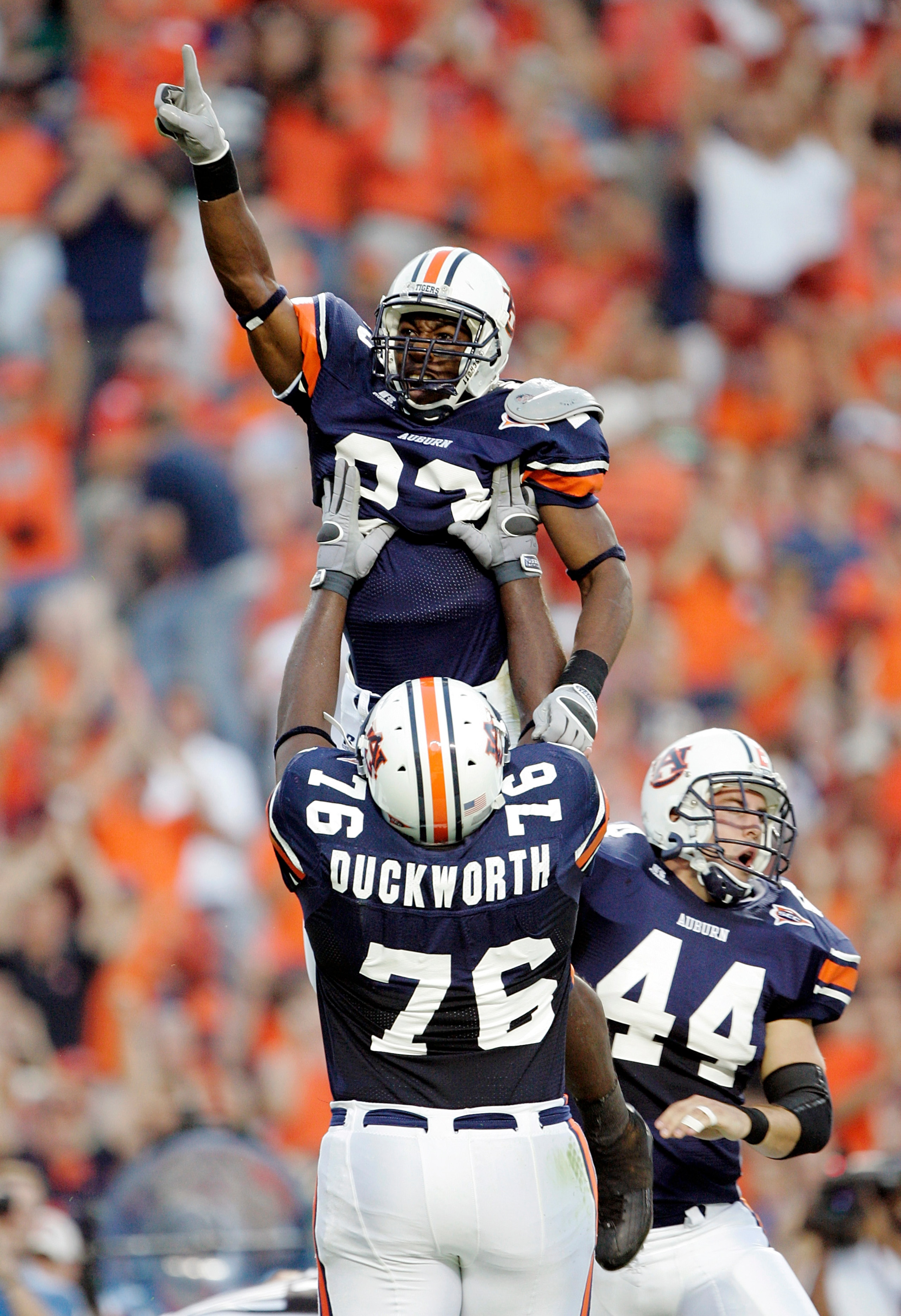 AUBURN, AL - OCTOBER 1: Running back Kenny Irons #23 of the Auburn Tigers gets a lift from guard Tim Duckworth #76 after scoring a touchdown against the South Carolina Gamecocks in the first quarter on October 1, 2005 at Jordan-Hare Stadium in Auburn, Al AUBURN, AL - OCTOBER 1: Running back Kenny Irons #23 of the Auburn Tigers gets a lift from guard Tim Duckworth #76 after scoring a touchdown against the South Carolina Gamecocks in the first quarter on October 1, 2005 at Jordan-Hare Stadium in Auburn, Al