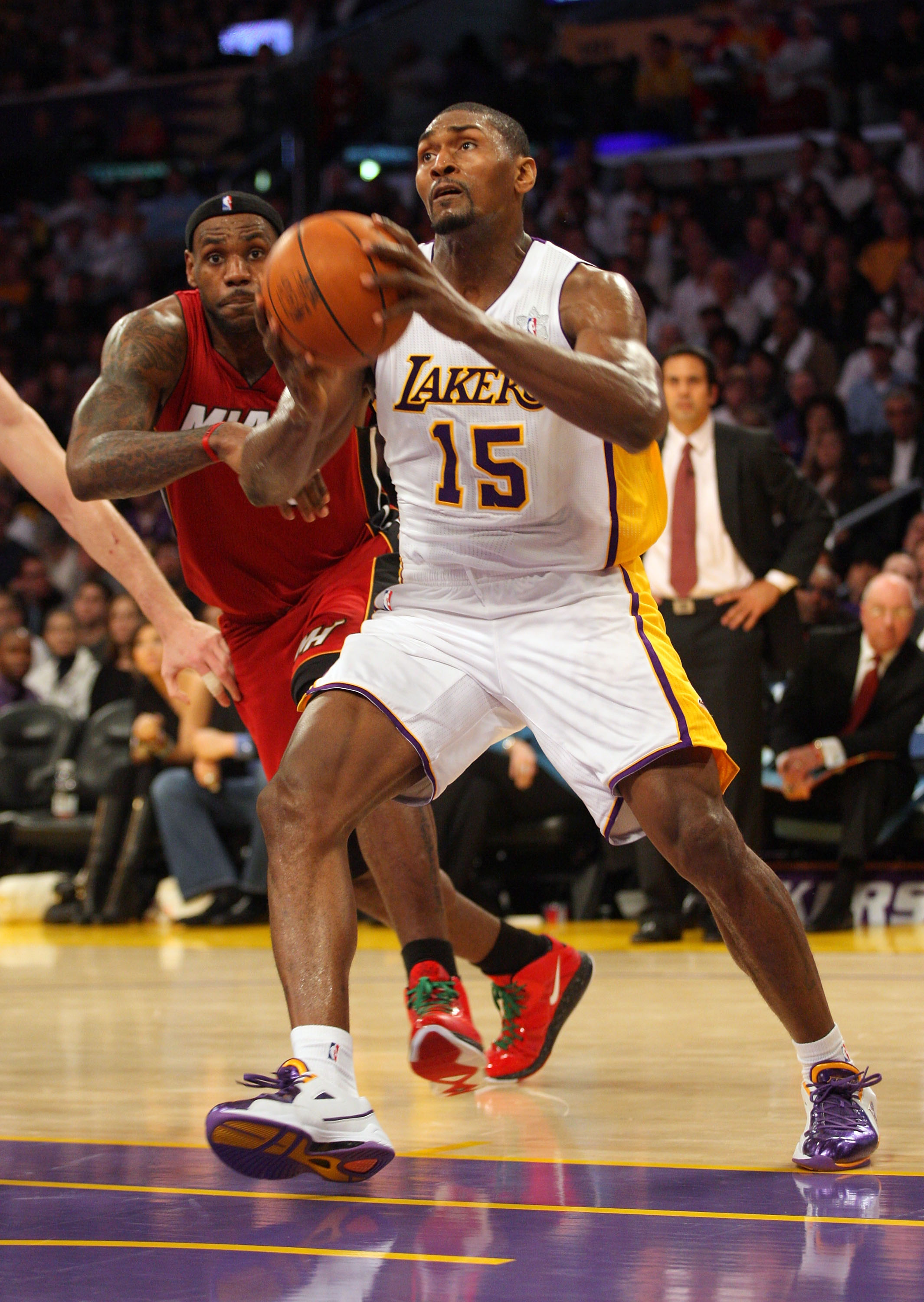 LOS ANGELES, CA - DECEMBER 25:  Ron Artest #15 of the Los Angeles Lakers steps to the basket as LeBron James #6 of the Miami Heat tries to defend the play during the NBA game at Staples Center on December 25, 2010 in Los Angeles, California. The Heat defe