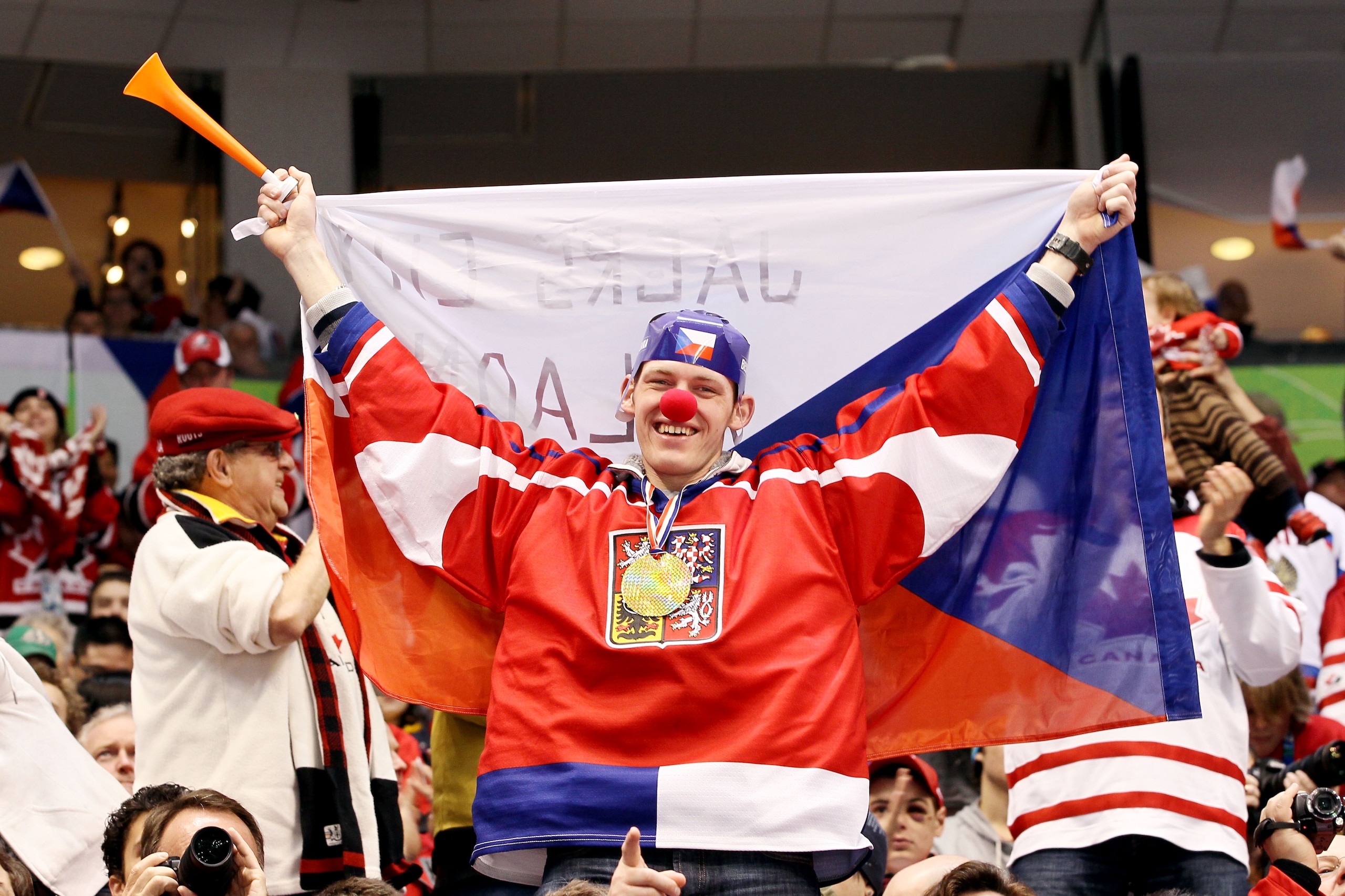 VANCOUVER, BC - FEBRUARY 21:  A fan of the Czech Republic holds up the countries flag as he supports the team during the ice hockey men's against the Russia Federation team on day 10 of the Vancouver 2010 Winter Olympics at Canada Hockey Place on February