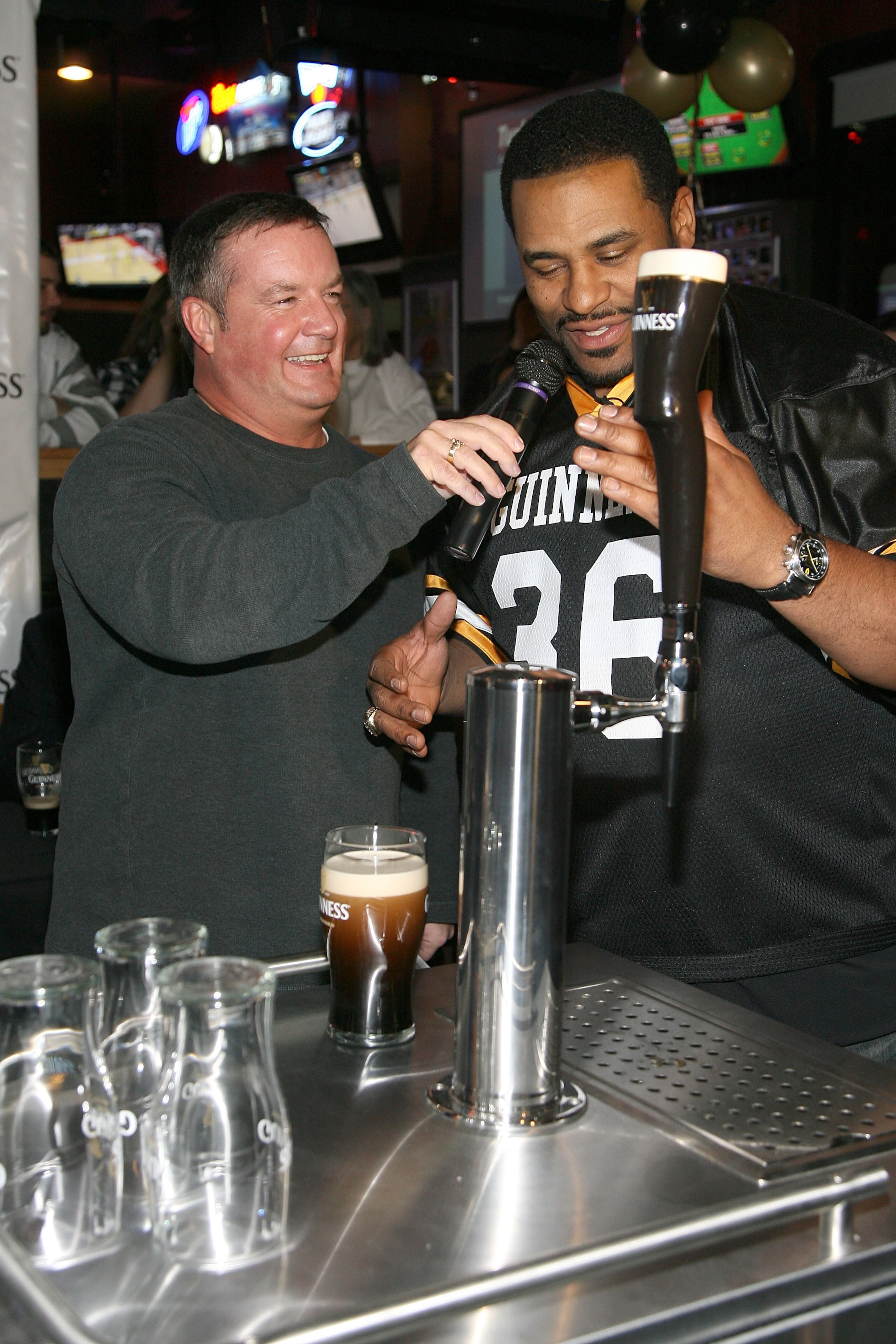 ARLINGTON, TX - FEBRUARY 03: Former NFL player Jerome Bettis (Right) competes in the Guinness Perfect Pint Pour-Off at Buffalo Wild Wings on February 3, 2011 in Arlington, Texas.  (Photo by Maury Phillips/Getty Images for Guinness)
