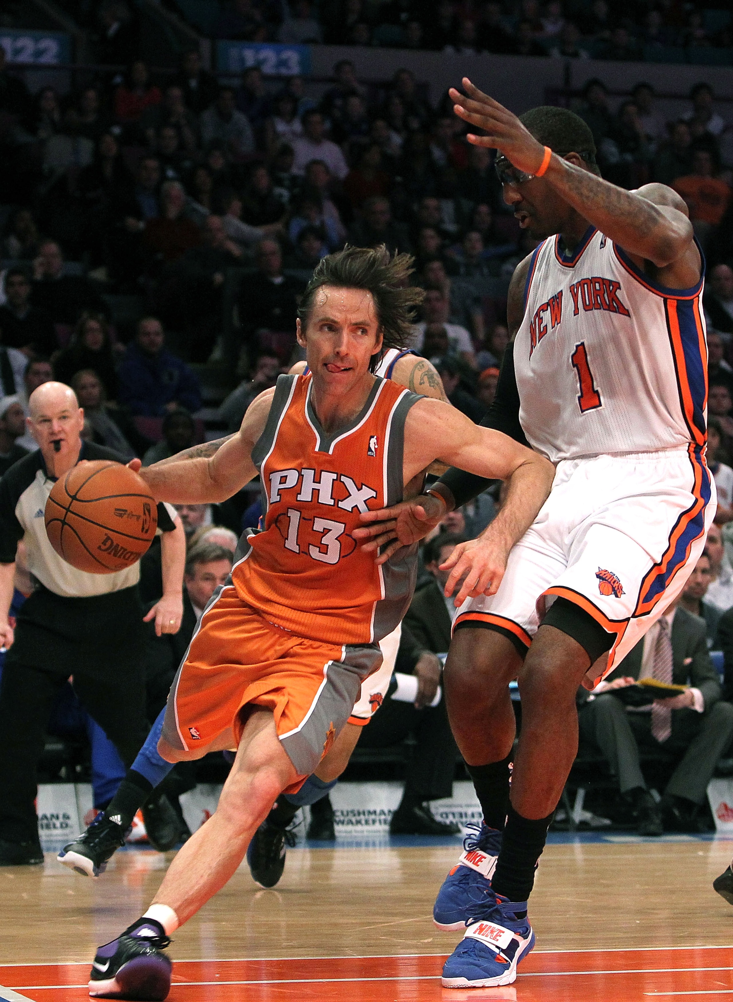 NEW YORK, NY - JANUARY 17:  Steve Nash #13 of the Phoenix Suns drives to the basket against Amar'e Stoudemire #1 of the New York Knicks at Madison Square Garden on January 17, 2011 in New York City. NOTE TO USER: User expressly acknowledges and agrees tha