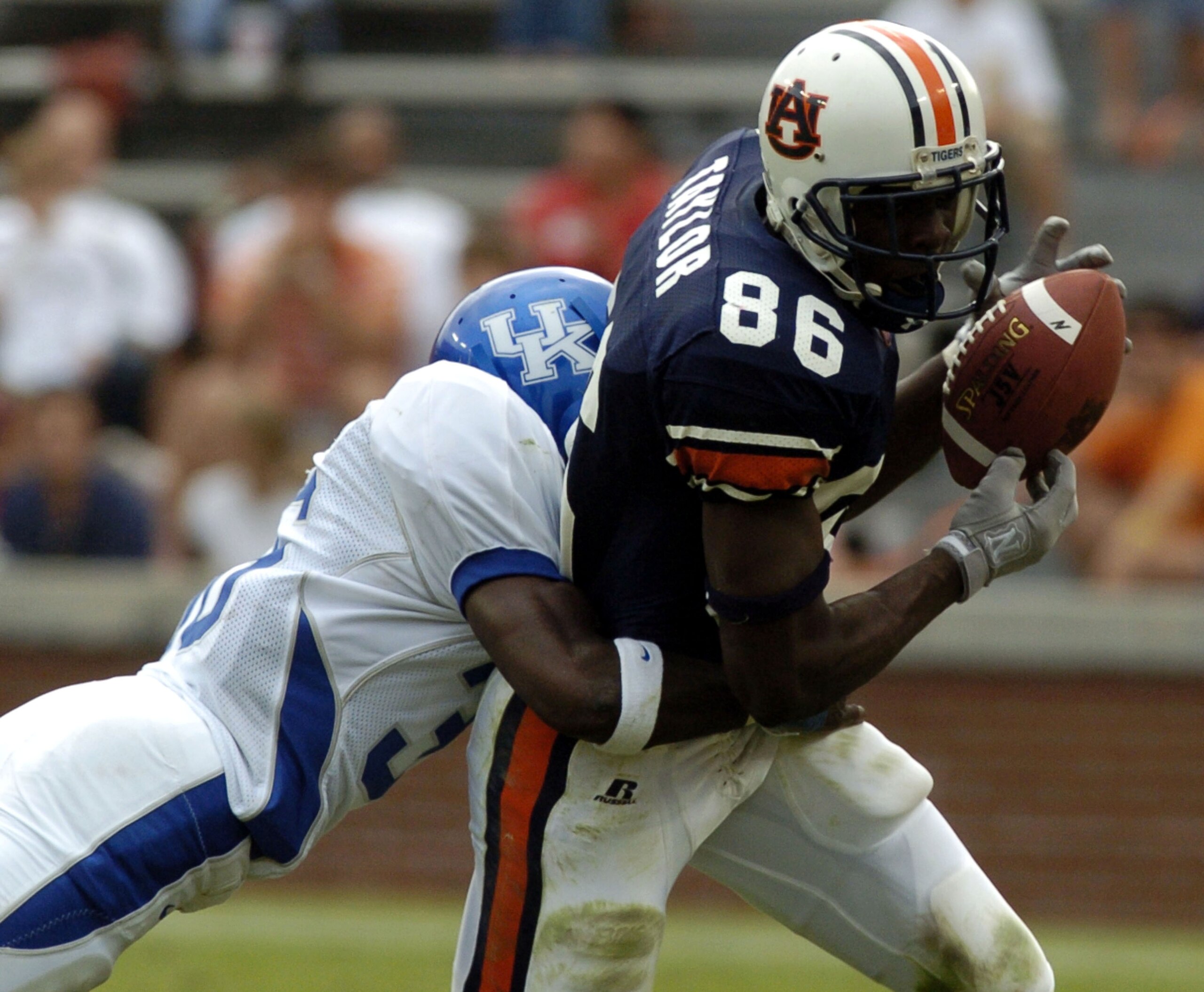 AUBURN, AL - OCTOBER 23: Courtney Taylor #86 of the Auburn Tigers is tackled by Antoine Huffman #36 of Kentucky Wildcats after making a first down catch on October 23, 2004 at Jordan-Hare Stadium in Auburn, Alabama. (Photo by Chris Graythen/Getty Image AUBURN, AL - OCTOBER 23: Courtney Taylor #86 of the Auburn Tigers is tackled by Antoine Huffman #36 of Kentucky Wildcats after making a first down catch on October 23, 2004 at Jordan-Hare Stadium in Auburn, Alabama. (Photo by Chris Graythen/Getty Image
