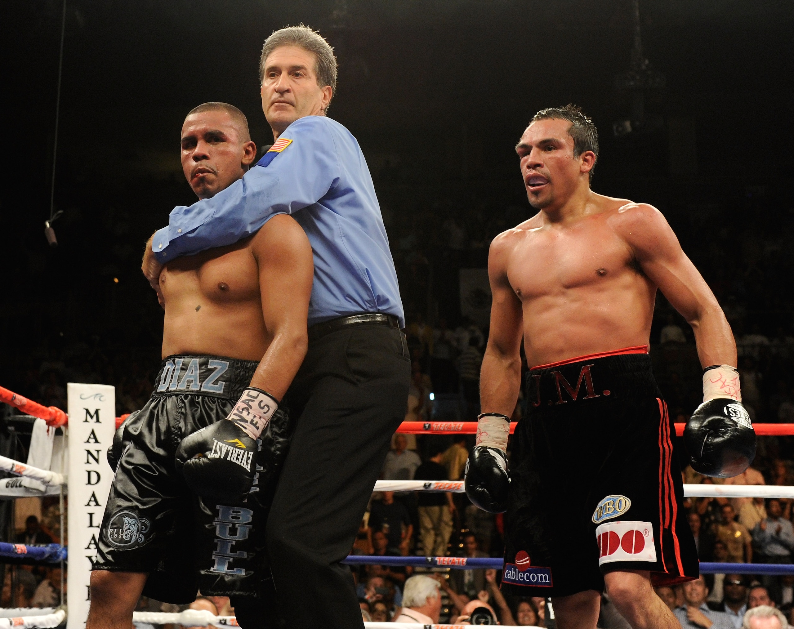 LAS VEGAS - JULY 31:  Referee Vik Drakulich separates Juan Diaz (L) and Juan Manuel Marquez (R) at the end of the final round of their bout at the Mandalay Bay Events Center July 31, 2010 in Las Vegas, Nevada. Marquez retained his WBA and WBO lightweight