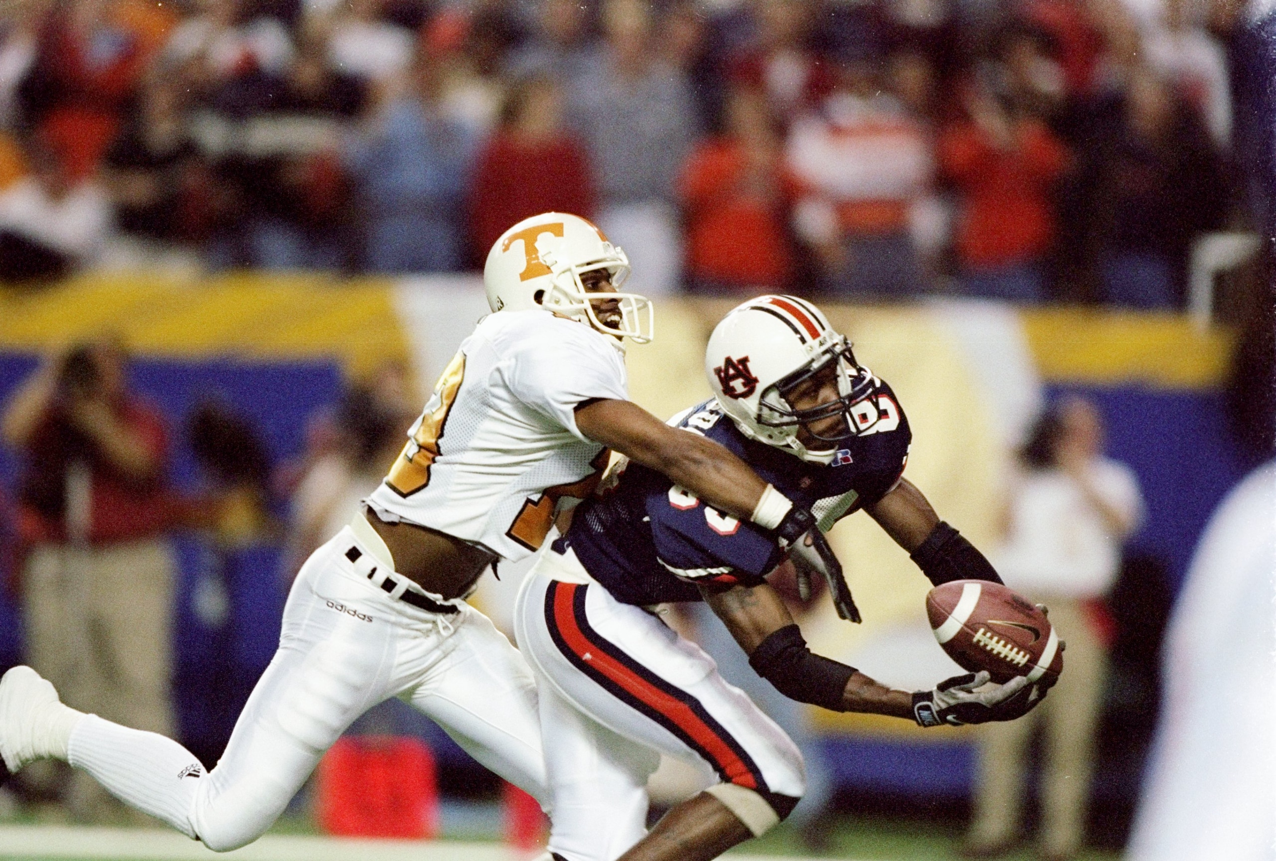 6 Dec 1997: Tyrone Goodson #83 of Auburn makes a catch on the defense of Terry Fair #13 of Tennessee during the Volunteers 30-29 win over Auburn in the SEC Championship at the Georgia Dome in Atlanta, Georgia. 6 Dec 1997: Tyrone Goodson #83 of Auburn makes a catch on the defense of Terry Fair #13 of Tennessee during the Volunteers 30-29 win over Auburn in the SEC Championship at the Georgia Dome in Atlanta, Georgia.