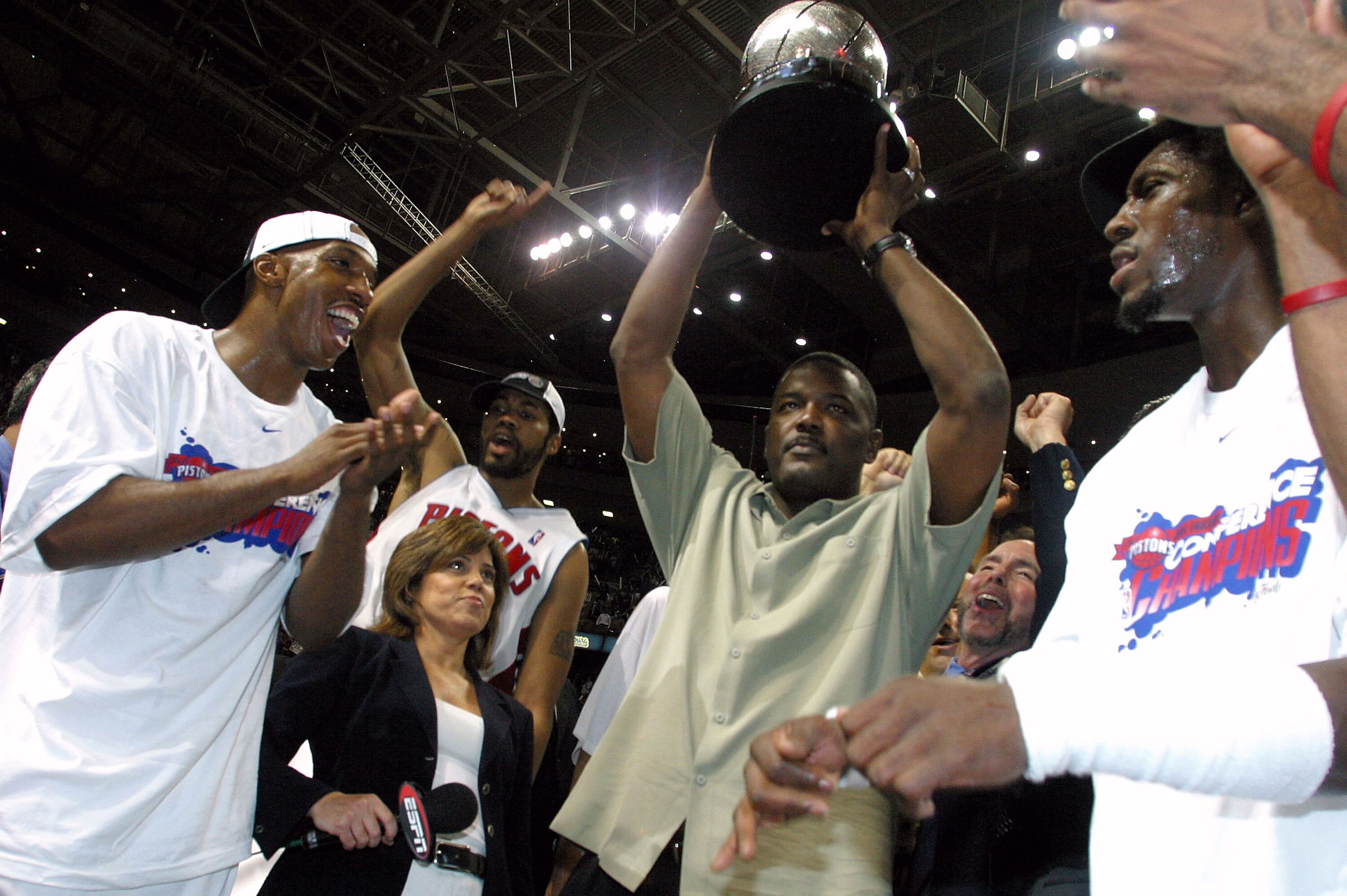 AUBURN HILLS, MI - JUNE 1:  (L-R) Chauncey Billups #1, Rasheed Wallace #30, President of Basketball Operations Joe Dumars (holding trophy) and Ben Wallace #3 of the Detroit Pistons celebrate their win over the Indiana Pacers in Game six of the Eastern Con
