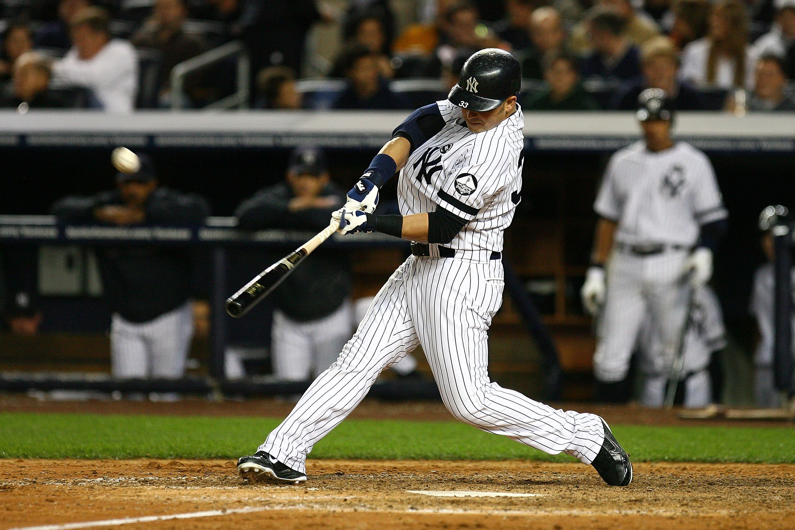 NEW YORK - OCTOBER 09:  Nick Swisher of the New York Yankees hits a solo home run in the bottom of the seventh inning against the Minnesota Twins during Game Three of the ALDS part of the 2010 MLB Playoffs at Yankee Stadium on October 9, 2010 in the Bronx