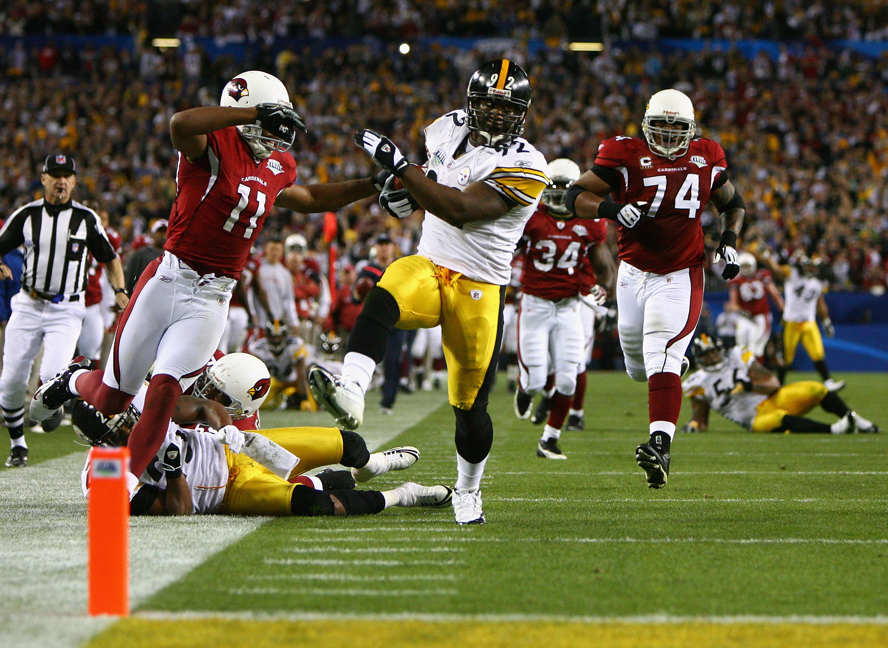 TAMPA, FL - FEBRUARY 01:  James Harrison #92 of the Pittsburgh Steelers scores a touchdown after running back an interception for 100 yards in the second quarter against Larry Fitzgerald #11 of the Arizona Cardinals during Super Bowl XLIII on February 1,