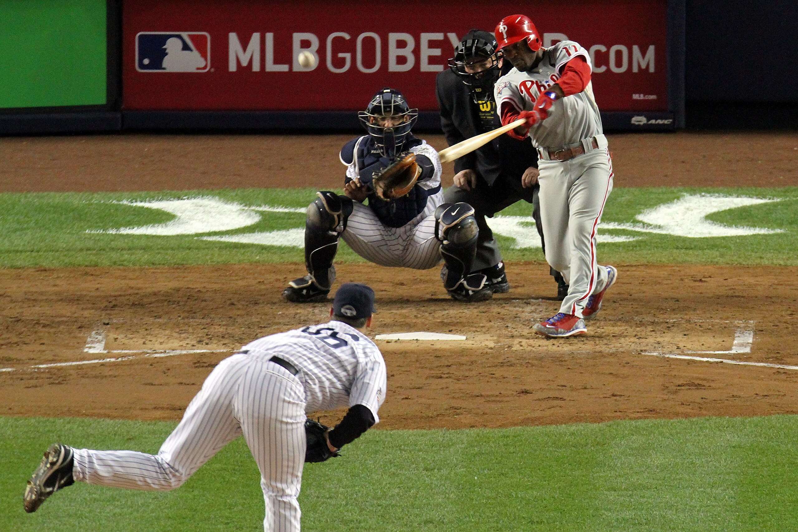 NEW YORK - NOVEMBER 04:  Jimmy Rollins #11 of the Philadelphia Phillies hits a sacrifice fly to drive in Carlos Ruiz #51 in the top of the third inning against Andy Pettitte #46 of the New York Yankees in Game Six of the 2009 MLB World Series at Yankee St