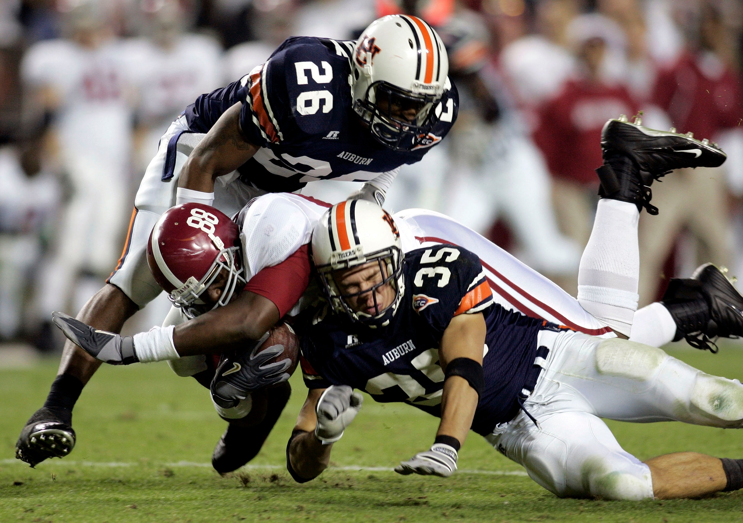 AUBURN, AL - NOVEMBER 19: Nick Walker #88 of the University of Alabama is tackled by Steve Gandy #26 and Will Herring #35 of Auburn University on November 19, 2005 at Jordan-Hare Stadium in Auburn, Alabama. Auburn defeated Alabama 28-18. (Photo by Chr AUBURN, AL - NOVEMBER 19: Nick Walker #88 of the University of Alabama is tackled by Steve Gandy #26 and Will Herring #35 of Auburn University on November 19, 2005 at Jordan-Hare Stadium in Auburn, Alabama. Auburn defeated Alabama 28-18. (Photo by Chr