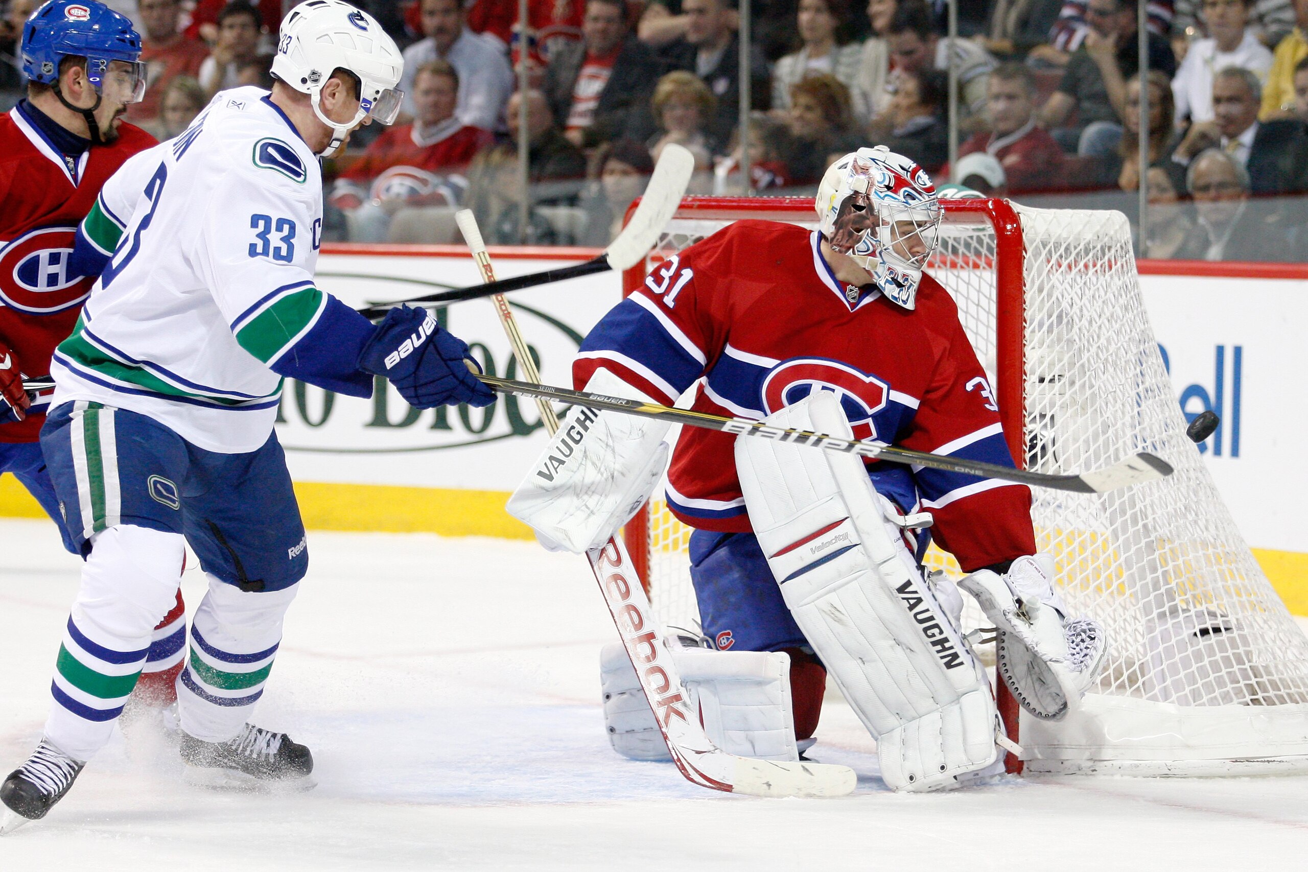 MONTREAL- NOVEMBER 9:  Carey Price #31 of the Montreal Canadiens stops the puck on an attempt by Henrik Sedin #33 of the Vancouver Canucks during the NHL game at the Bell Centre on November 9, 2010 in Montreal, Quebec, Canada.  The Canadiens defeated the