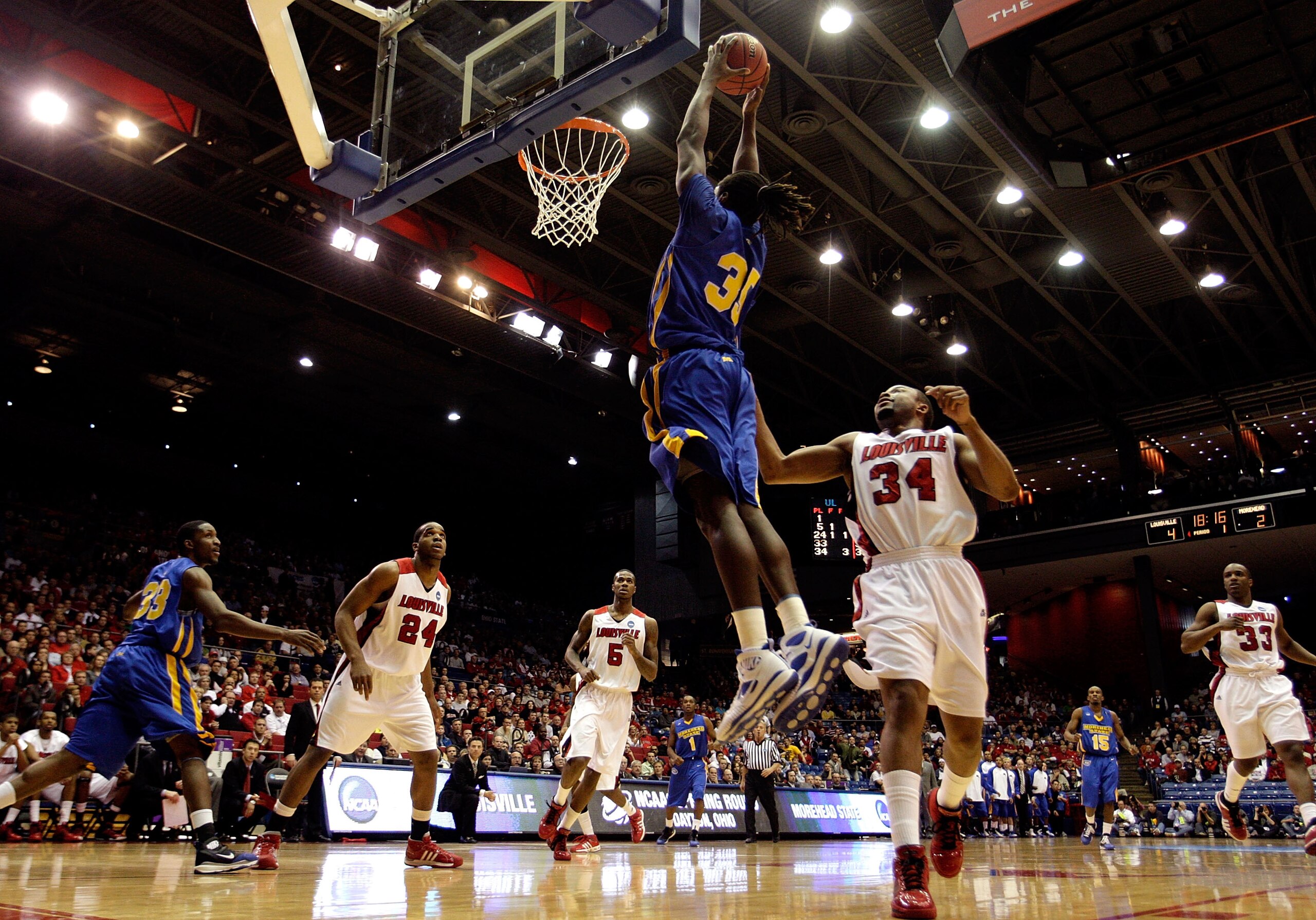 DAYTON, OH - MARCH 20: Kenneth Faried #35 of the Morehead State Eagles drives to the hoop against Jerry Smith #34 of the Louisville Cardinals during the first round of the NCAA Division I Men's Basketball Tournament at the University of Dayton Arena on Ma DAYTON, OH - MARCH 20: Kenneth Faried #35 of the Morehead State Eagles drives to the hoop against Jerry Smith #34 of the Louisville Cardinals during the first round of the NCAA Division I Men's Basketball Tournament at the University of Dayton Arena on Ma