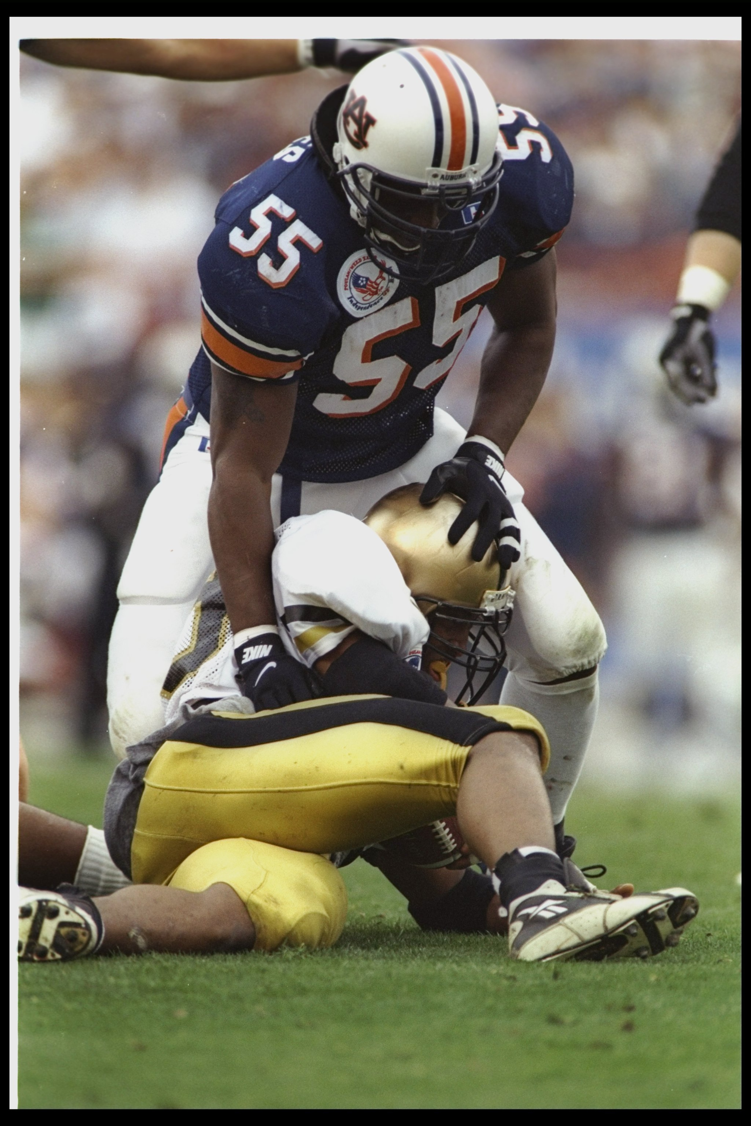 31 Dec 1996: Linebacker Takeo Spikes of the Auburn Tigers looms over an Army Cadets player during the Independence Bowl at the Independence Bowl in Shreveport, Louisiana. Auburn won the game, 32-29. Mandatory Credit: Brian Bahr /Allsport 31 Dec 1996: Linebacker Takeo Spikes of the Auburn Tigers looms over an Army Cadets player during the Independence Bowl at the Independence Bowl in Shreveport, Louisiana. Auburn won the game, 32-29. Mandatory Credit: Brian Bahr /Allsport