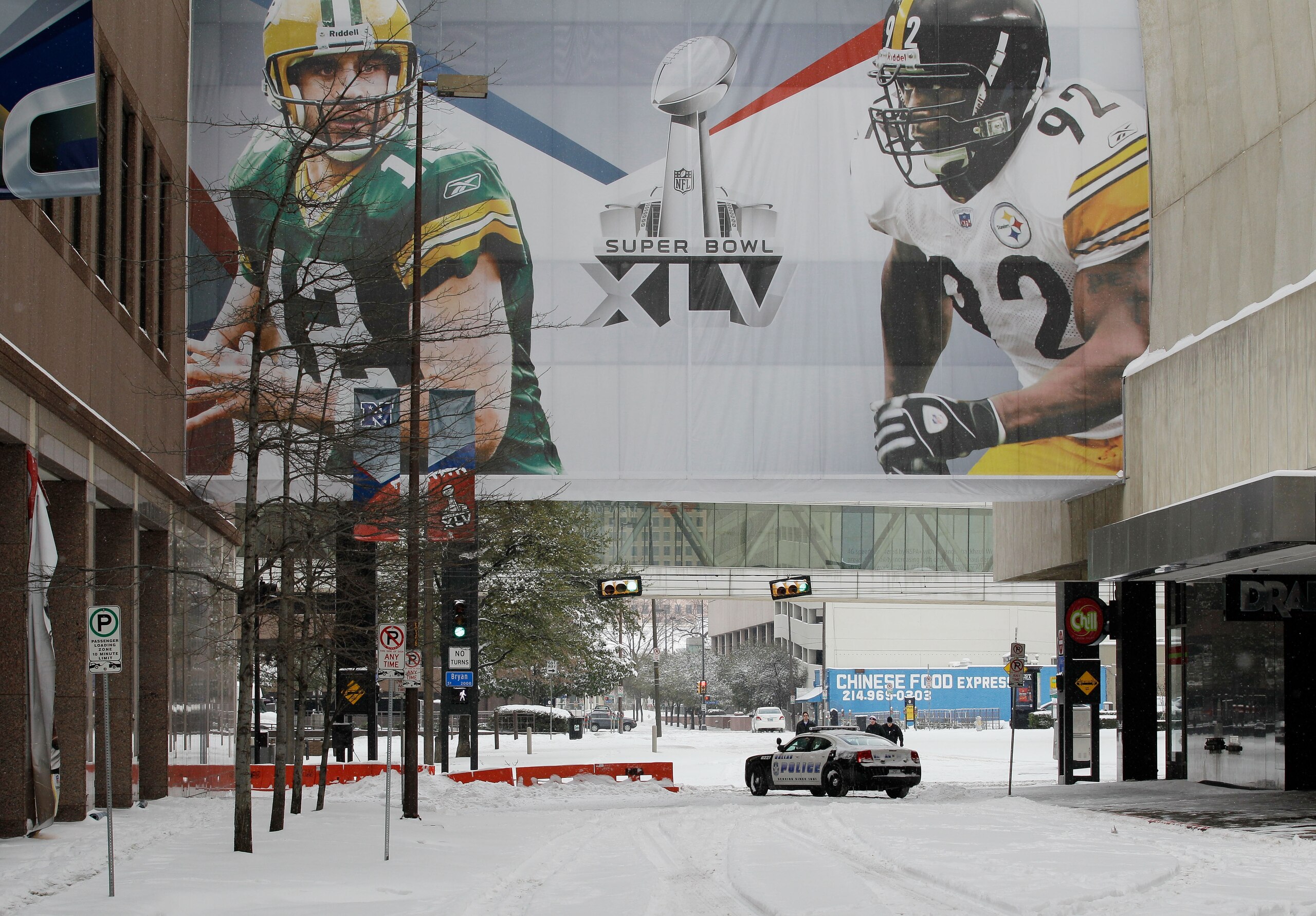 DALLAS, TX - FEBRUARY 04:  A police car is parked on a snow covered street under a Super Bowl XLV sign February 4, 2011 in Dallas, Texas. More than four inches of snow fell overnight in the North Texas area. The Green Bay Packers will play the Pittsburgh