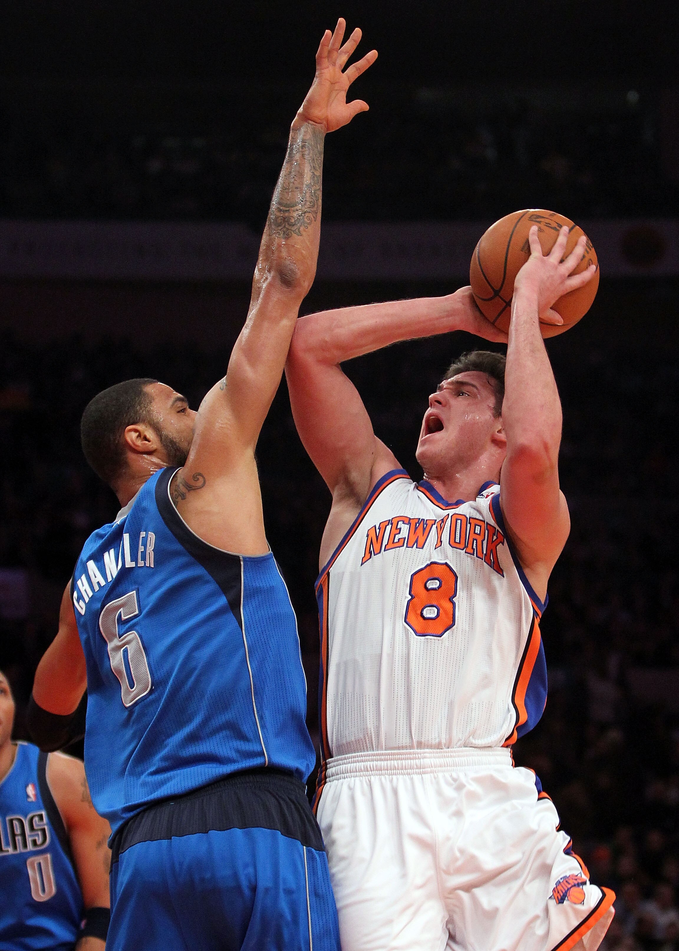 NEW YORK, NY - FEBRUARY 02:  Danilo Gallinari #8 of the New York Knicks shoots the ball against Tyson Chandler #6 of the Dallas Mavericks at Madison Square Garden on February 2, 2011 in New York City. NOTE TO USER: User expressly acknowledges and agrees t