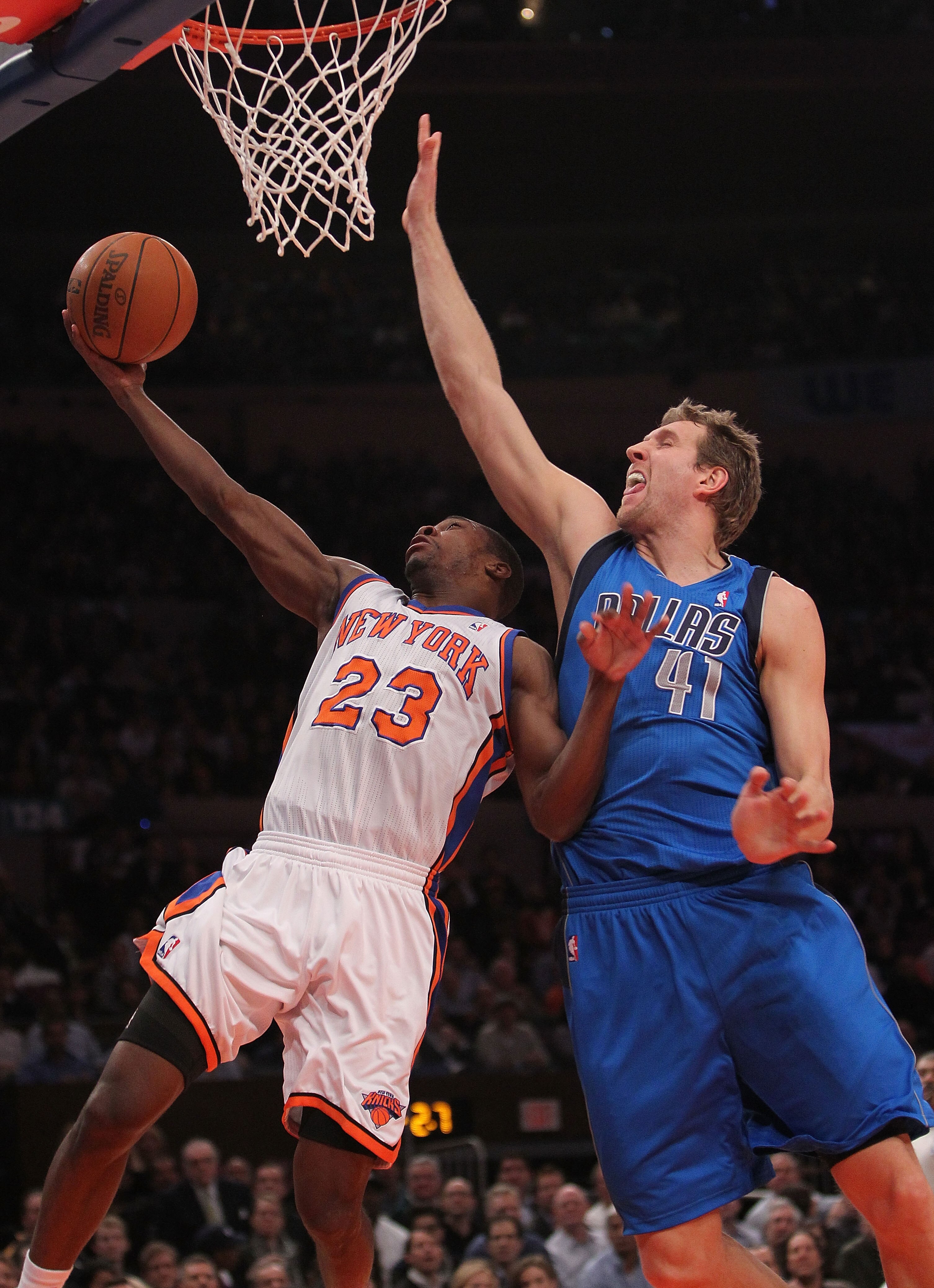 NEW YORK, NY - FEBRUARY 02: Toney Douglas #23 of the New York Knicks lays the ball up under Dirk Nowitzki #41 of the Dallas Mavericks at Madison Square Garden on February 2, 2011 in New York City. NOTE TO USER: User expressly acknowledges and agrees that,