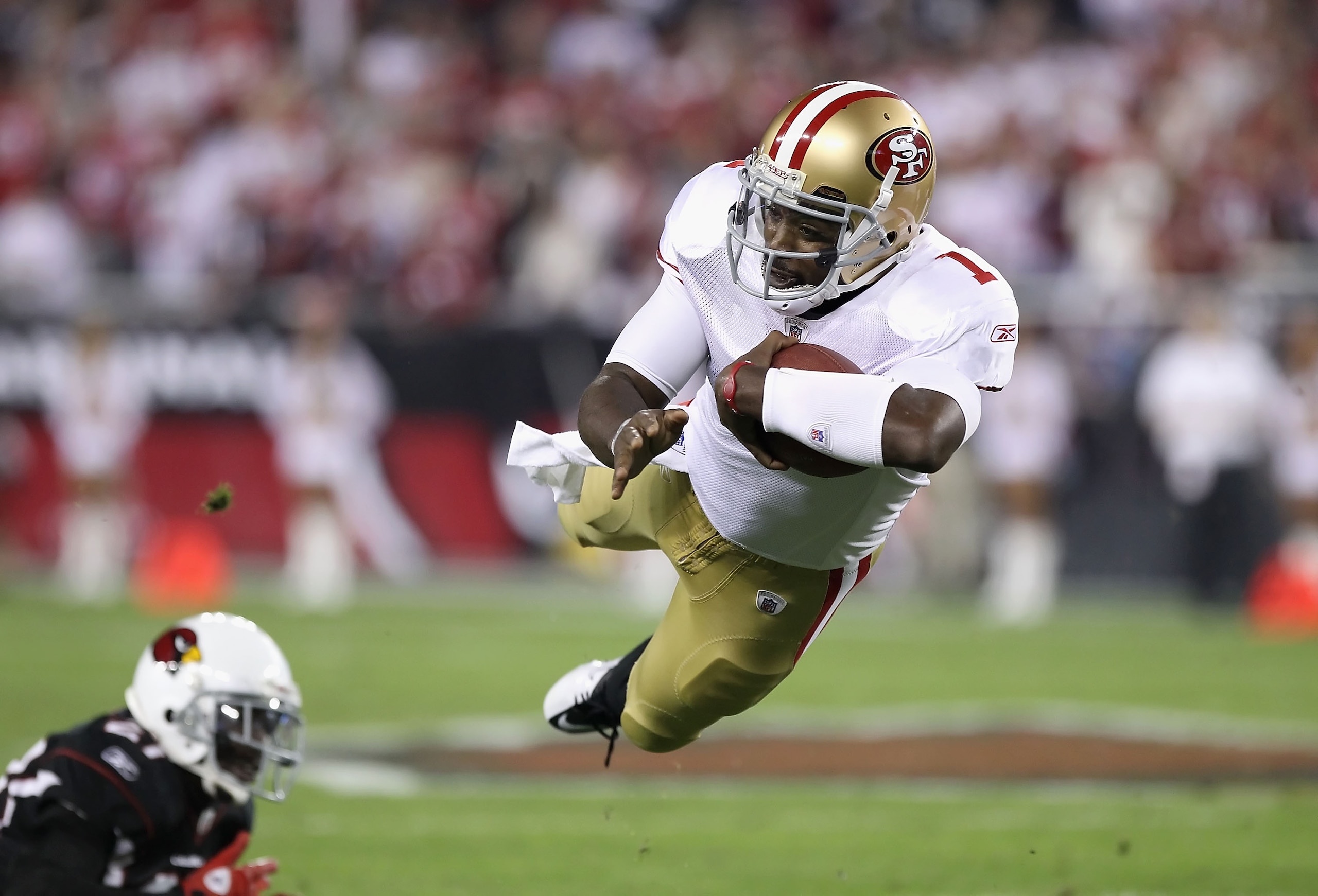 GLENDALE, AZ - NOVEMBER 29:  Quarterback Troy Smith #1 of the San Francisco 49ers dives for a first down against the Arizona Cardinals during the first quarter of the NFL game at the University of Phoenix Stadium on November 29, 2010 in Glendale, Arizona.
