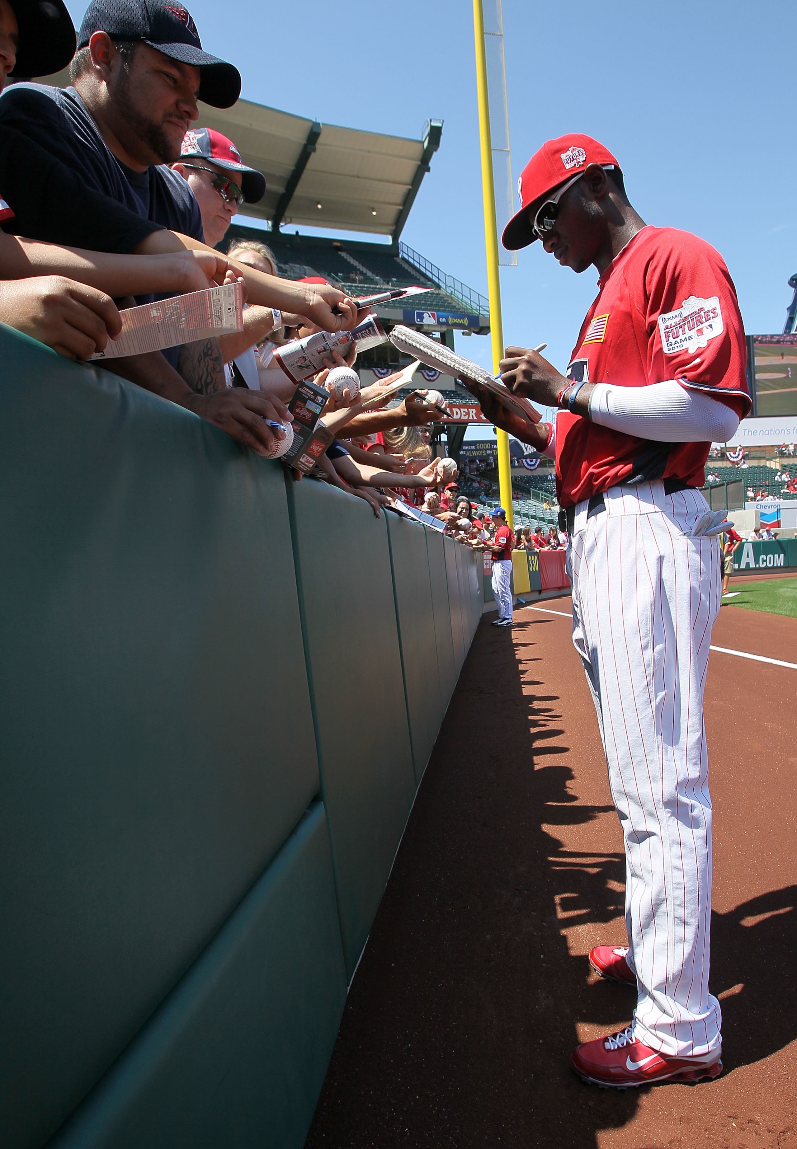 ANAHEIM, CA - JULY 11:  U.S. Futures All-Star Domonic Brown #3 of the Philadelphia Phillies signs autographs before the 2010 XM All-Star Futures Game at Angel Stadium of Anaheim on July 11, 2010 in Anaheim, California.  (Photo by Stephen Dunn/Getty Images
