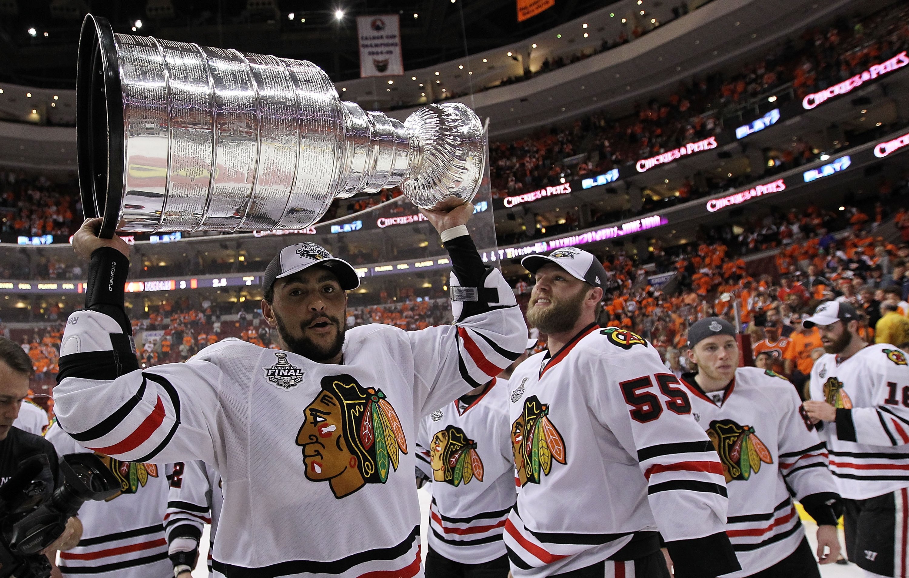 PHILADELPHIA - JUNE 09: Dustin Byfuglien #33 of the Chicago Blackhawks hoists the Stanley Cup after the Blackhawks defeated the Philadelphia Flyers 4-3 in overtime to win the Stanley Cup in Game Six of the 2010 NHL Stanley Cup Final at the Wachovia Center