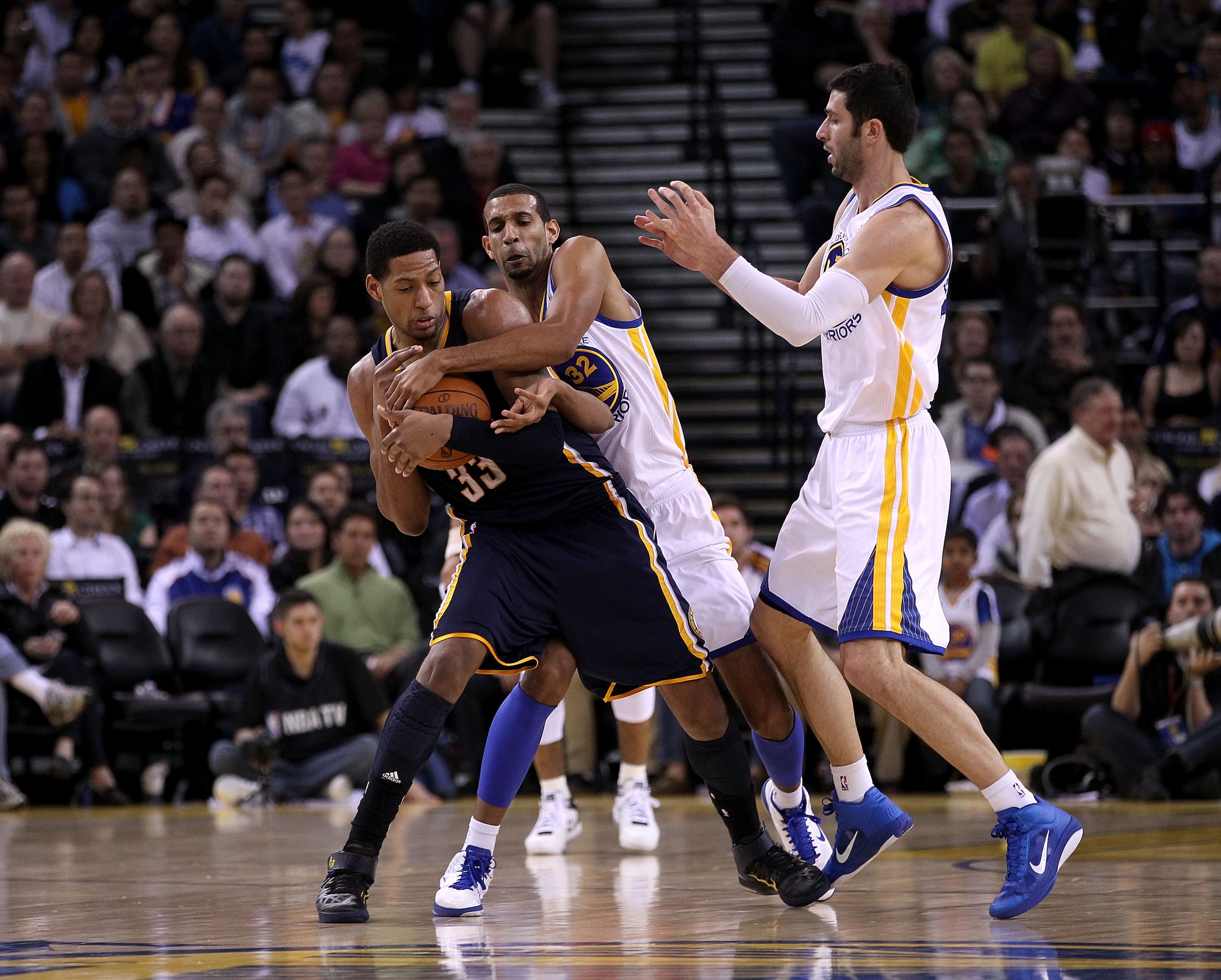 OAKLAND, CA - JANUARY 19:  Danny Granger #33 of the Indiana Pacers is surrounded by Brandan Wright #32 and Vladimir Radmanovic #77 of the Golden State Warriors at Oracle Arena on January 19, 2011 in Oakland, California.  NOTE TO USER: User expressly ackno