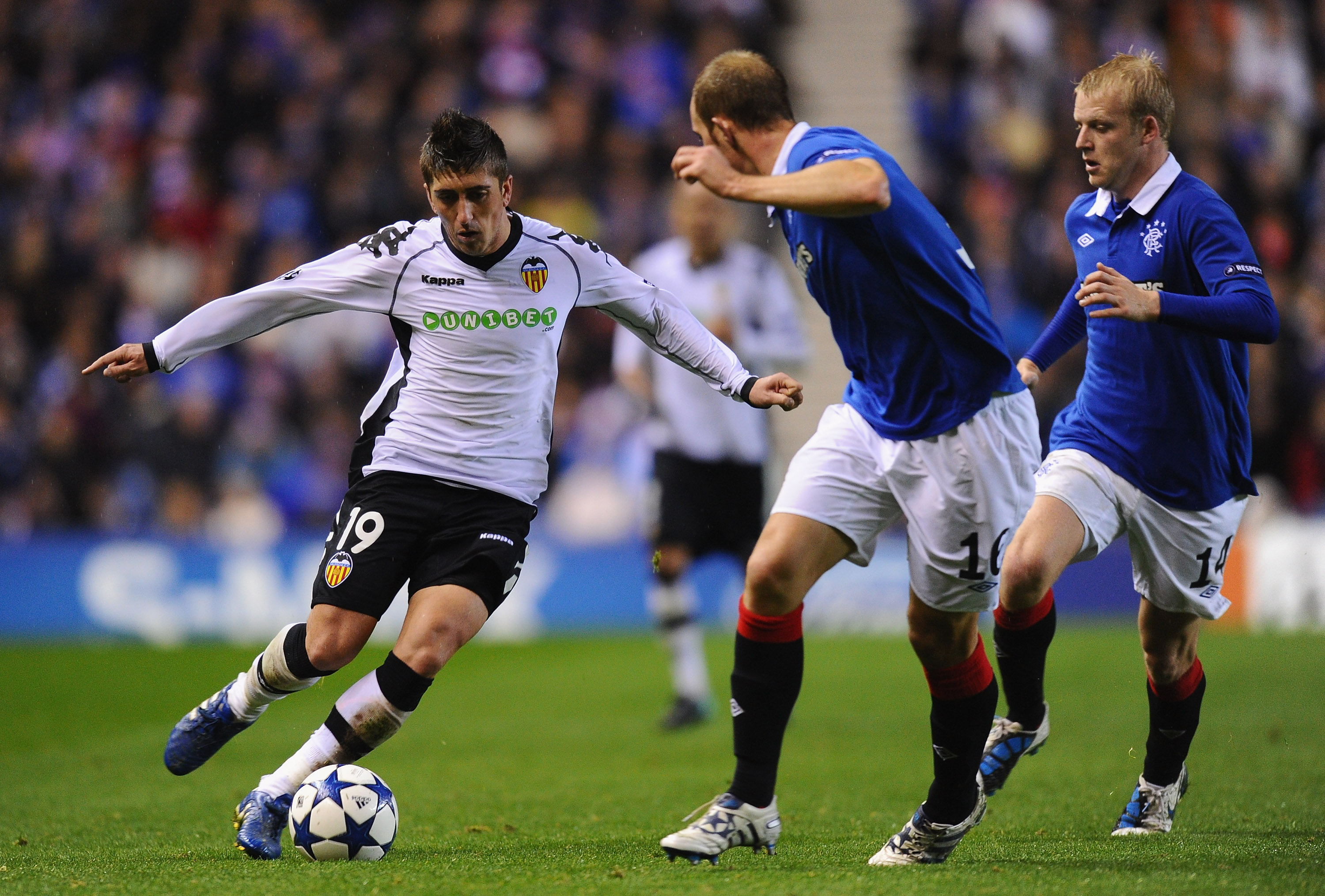 GLASGOW, SCOTLAND - OCTOBER 20: Pablo Hernandez of Valencia takes on the Rangers defence during the UEFA Champions League Group C match between Glasgow Rangers FC and Valencia at Ibrox Stadium on October 20, 2010 in Glasgow, Scotland. (Photo by Mike Hew