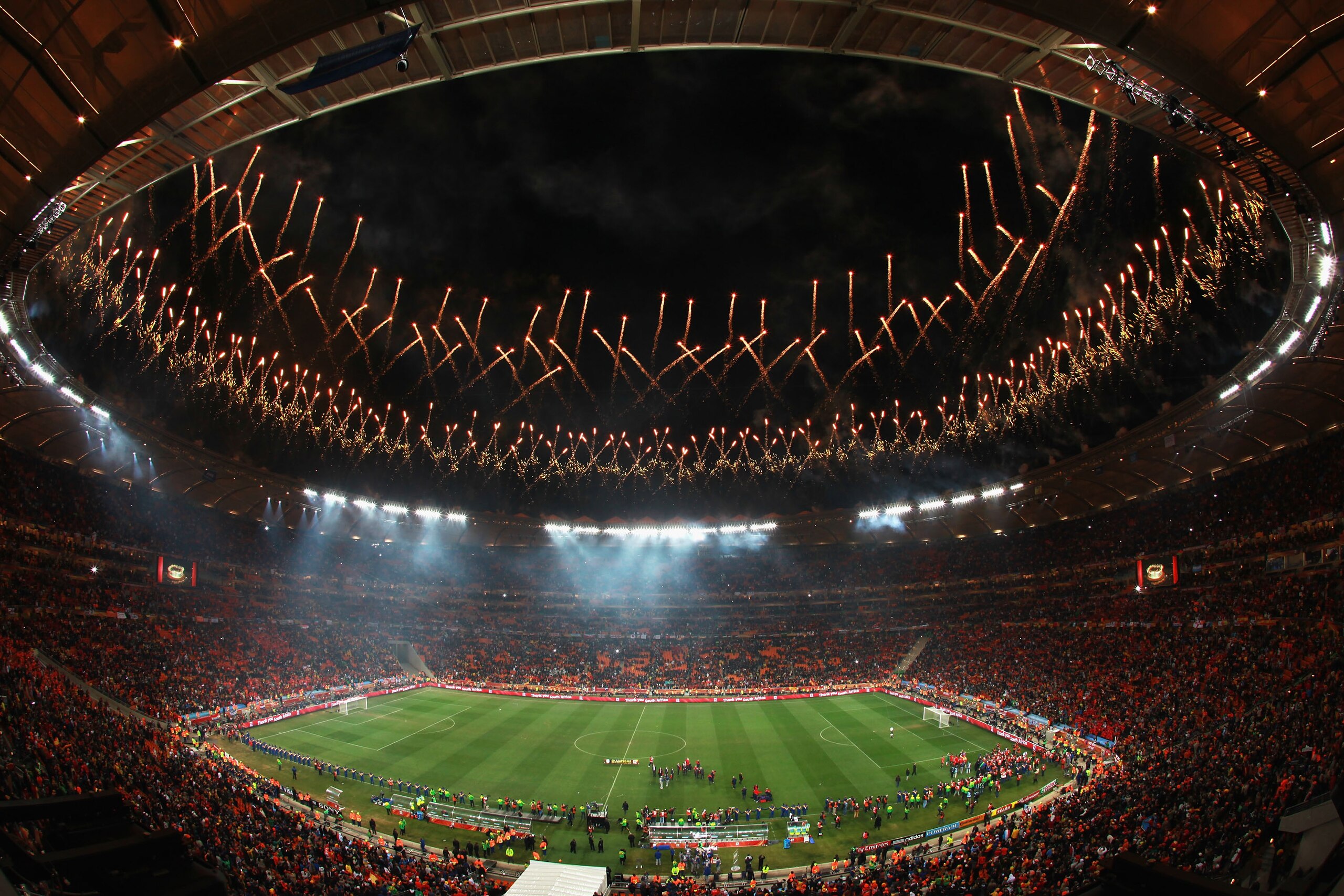 JOHANNESBURG, SOUTH AFRICA - JULY 11: Fireworks explode as the Spain team celebrate victory with the World Cup trophy following the 2010 FIFA World Cup South Africa Final match between Netherlands and Spain at Soccer City Stadium on July 11, 2010 in Joha JOHANNESBURG, SOUTH AFRICA - JULY 11: Fireworks explode as the Spain team celebrate victory with the World Cup trophy following the 2010 FIFA World Cup South Africa Final match between Netherlands and Spain at Soccer City Stadium on July 11, 2010 in Joha
