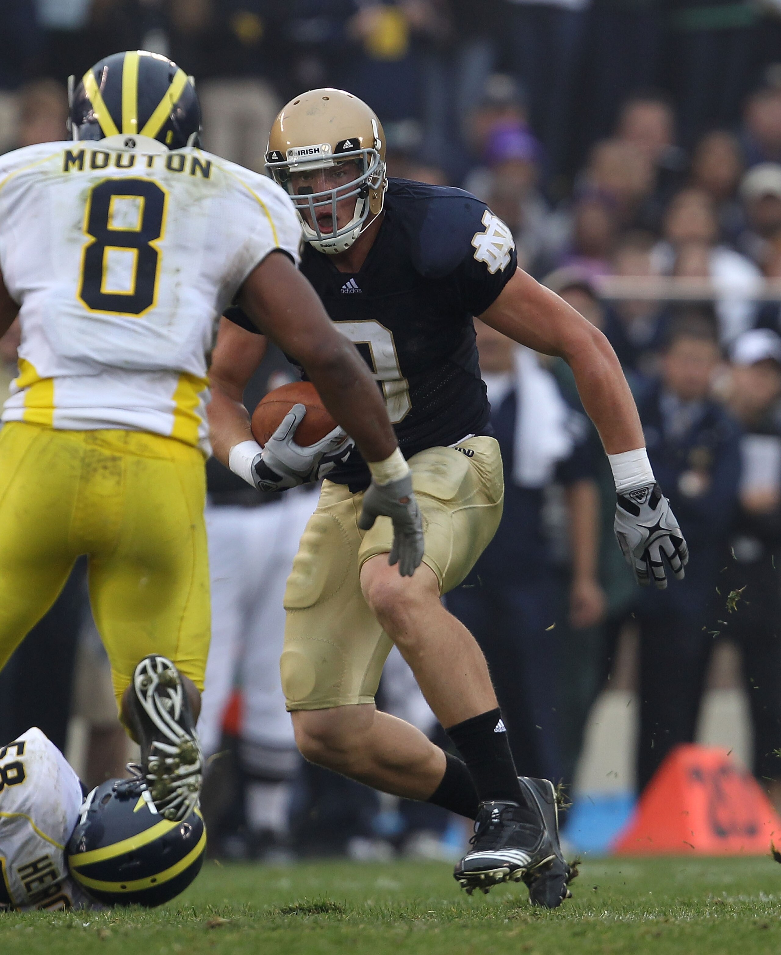 SOUTH BEND, IN - SEPTEMBER 11: Kyle Randolph #9 of the Notre Dame Fighting Irish runs as Jonas Mouton #8 of the Michigan Wolverines closes in at Notre Dame Stadium on September 11, 2010 in South Bend, Indiana. Michigan defeated Notre Dame 28-24. (Photo b SOUTH BEND, IN - SEPTEMBER 11: Kyle Randolph #9 of the Notre Dame Fighting Irish runs as Jonas Mouton #8 of the Michigan Wolverines closes in at Notre Dame Stadium on September 11, 2010 in South Bend, Indiana. Michigan defeated Notre Dame 28-24. (Photo b