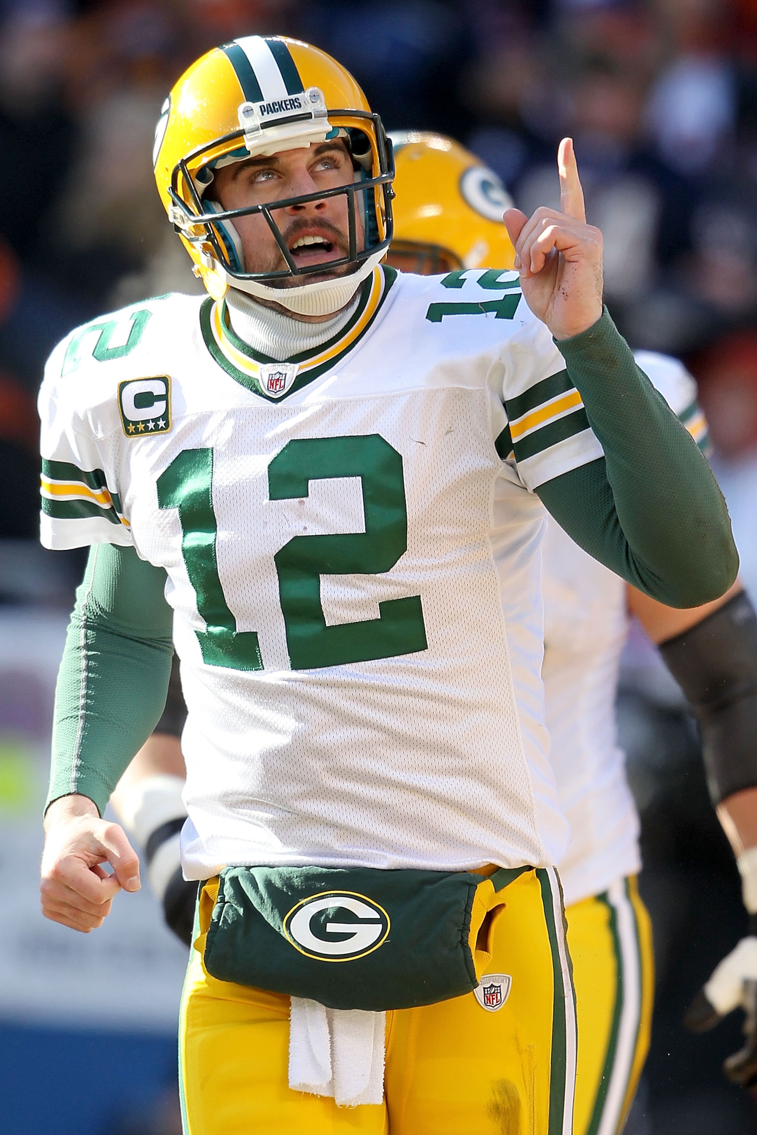 CHICAGO, IL - JANUARY 23:  Quarterback Aaron Rodgers #12 of the Green Bay Packers reacts after he scores a one-yard touchdown against the Chicago Bears in the first quarter of the NFC Championship Game at Soldier Field on January 23, 2011 in Chicago, Illi
