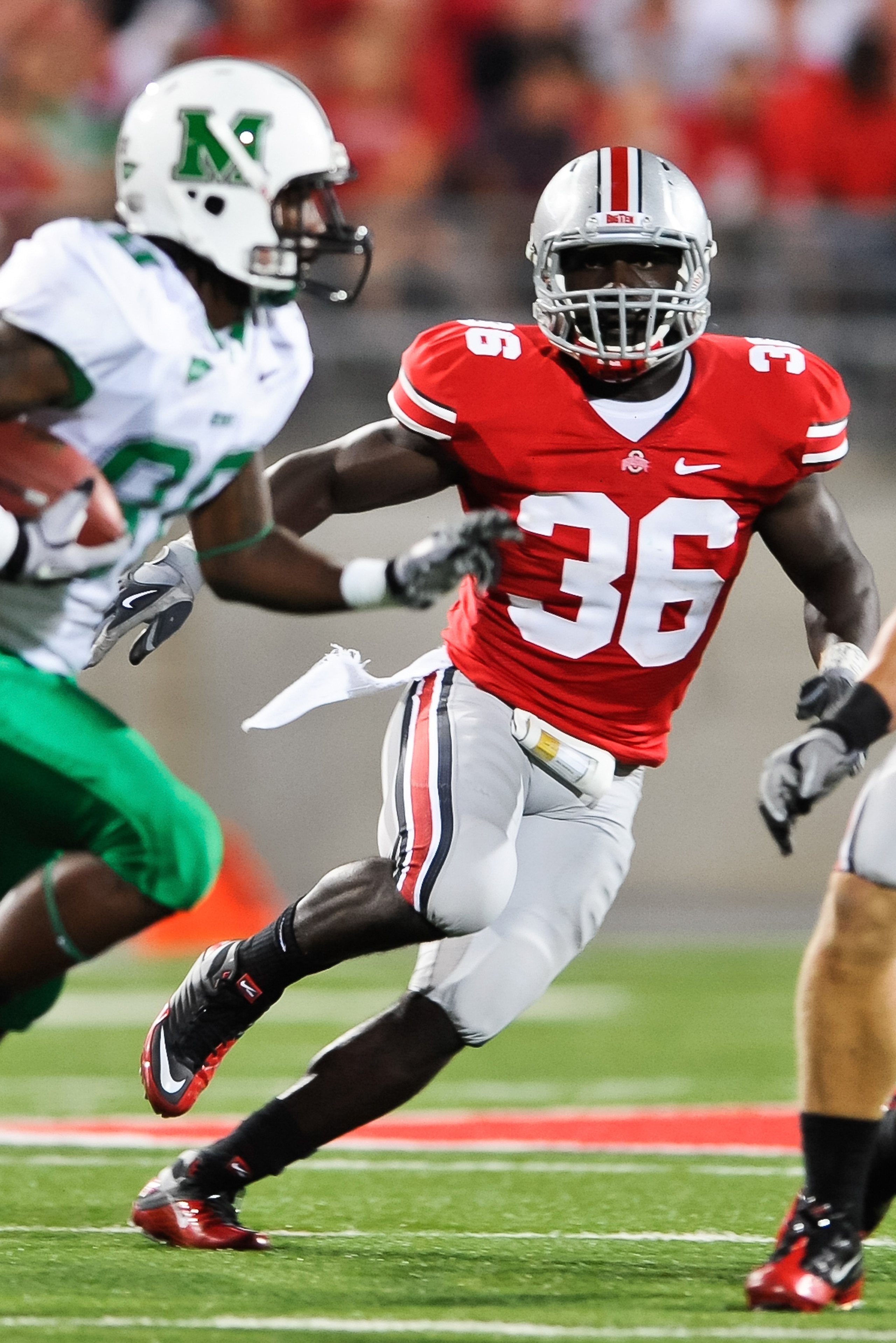 COLUMBUS, OH - SEPTEMBER 2: Brian Rolle #36 of the Ohio State Buckeyes pursues ballcarrier Courtney Edmonson #80 of the Marshall Thundering Herd at Ohio Stadium on September 2, 2010 in Columbus, Ohio. (Photo by Jamie Sabau/Getty Images)