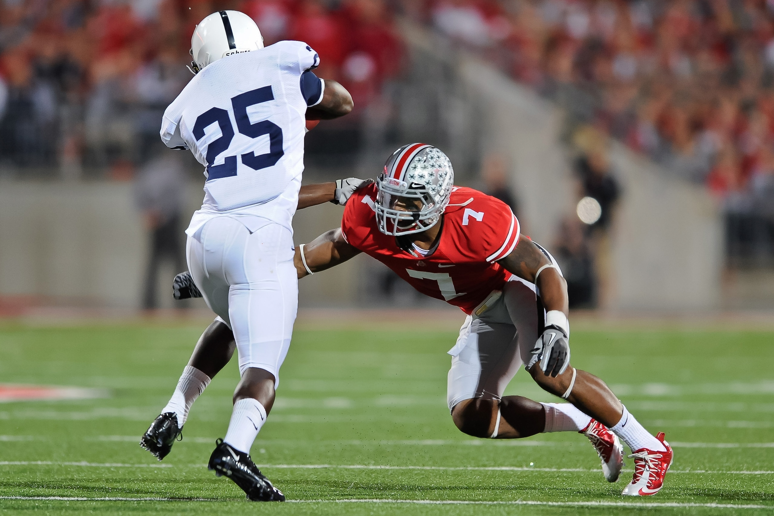 COLUMBUS, OH - NOVEMBER 13:  Jermale Hines #7 of the Ohio State Buckeyes tackles Silas Redd #25 of the Penn State Nittany Lions at Ohio Stadium on November 13, 2010 in Columbus, Ohio.  (Photo by Jamie Sabau/Getty Images)