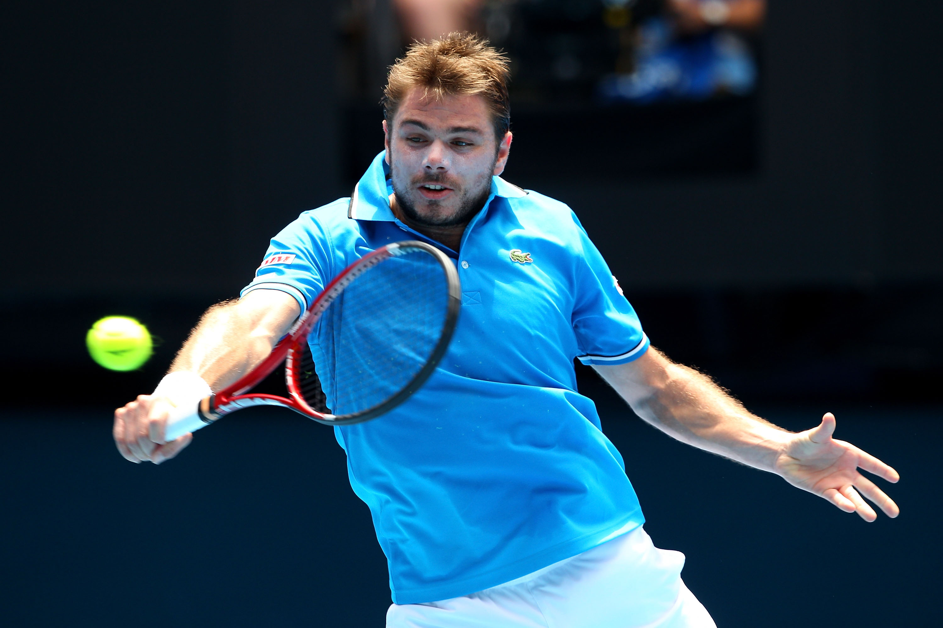 MELBOURNE, AUSTRALIA - JANUARY 25:  Stanislas Wawrinka of Switzerland plays a backhand in his quarterfinal match against Roger Federer of Switzerland during day nine of the 2011 Australian Open at Melbourne Park on January 25, 2011 in Melbourne, Australia