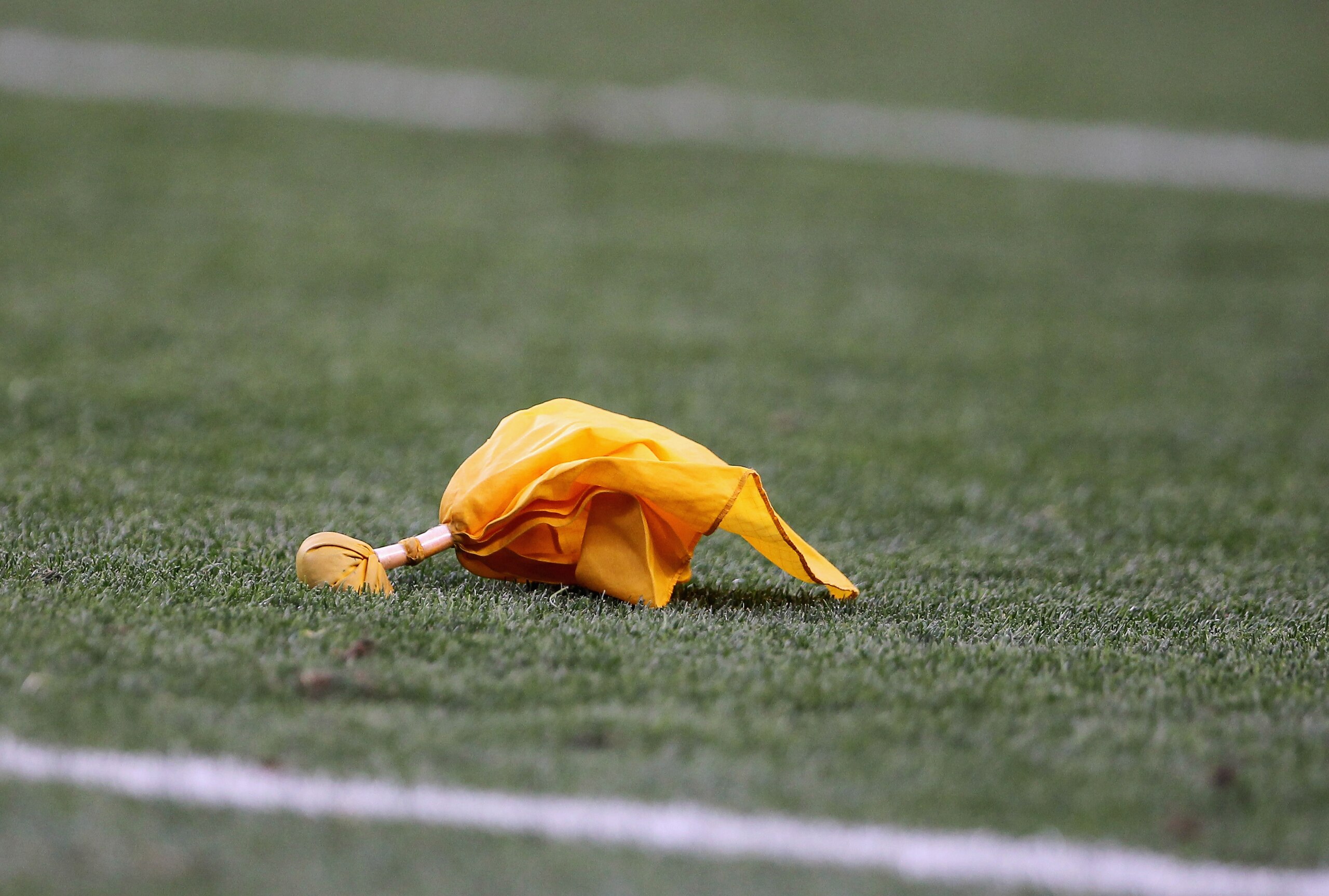 DENVER - AUGUST 21:  A penalty flag rests on the field after a call between the Denver Broncos and the Detroit Lions during preseason NFL action at INVESCO Field at Mile High on August 21, 2010 in Denver, Colorado. The Lions defeated the Broncos 25-20.  (