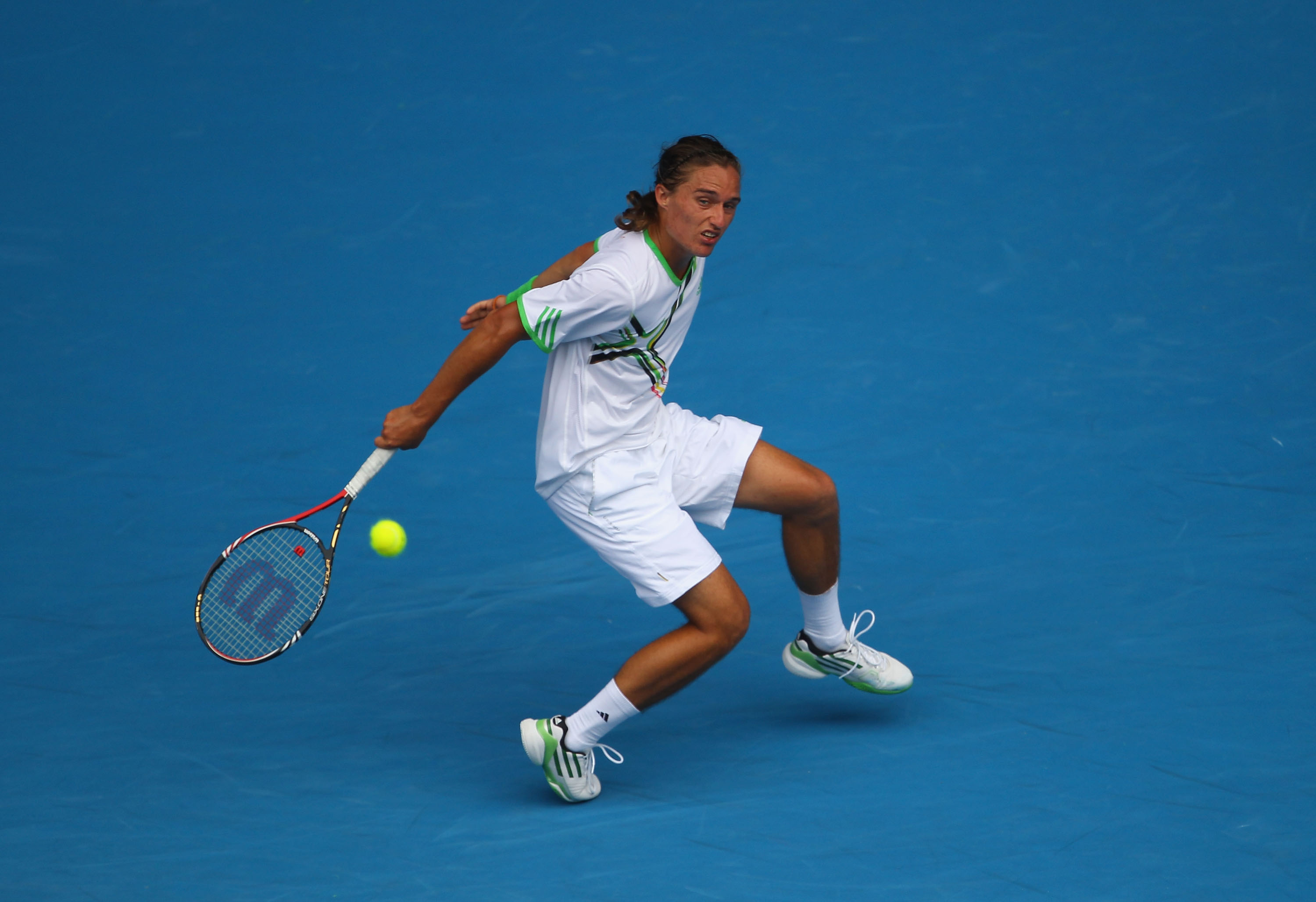 MELBOURNE, AUSTRALIA - JANUARY 26:  Alexandr Dolgopolov of the Ukraine plays a backhand in his quarterfinal match against Andy Murray of Great Britain during day ten of the 2011 Australian Open at Melbourne Park on January 26, 2011 in Melbourne, Australia