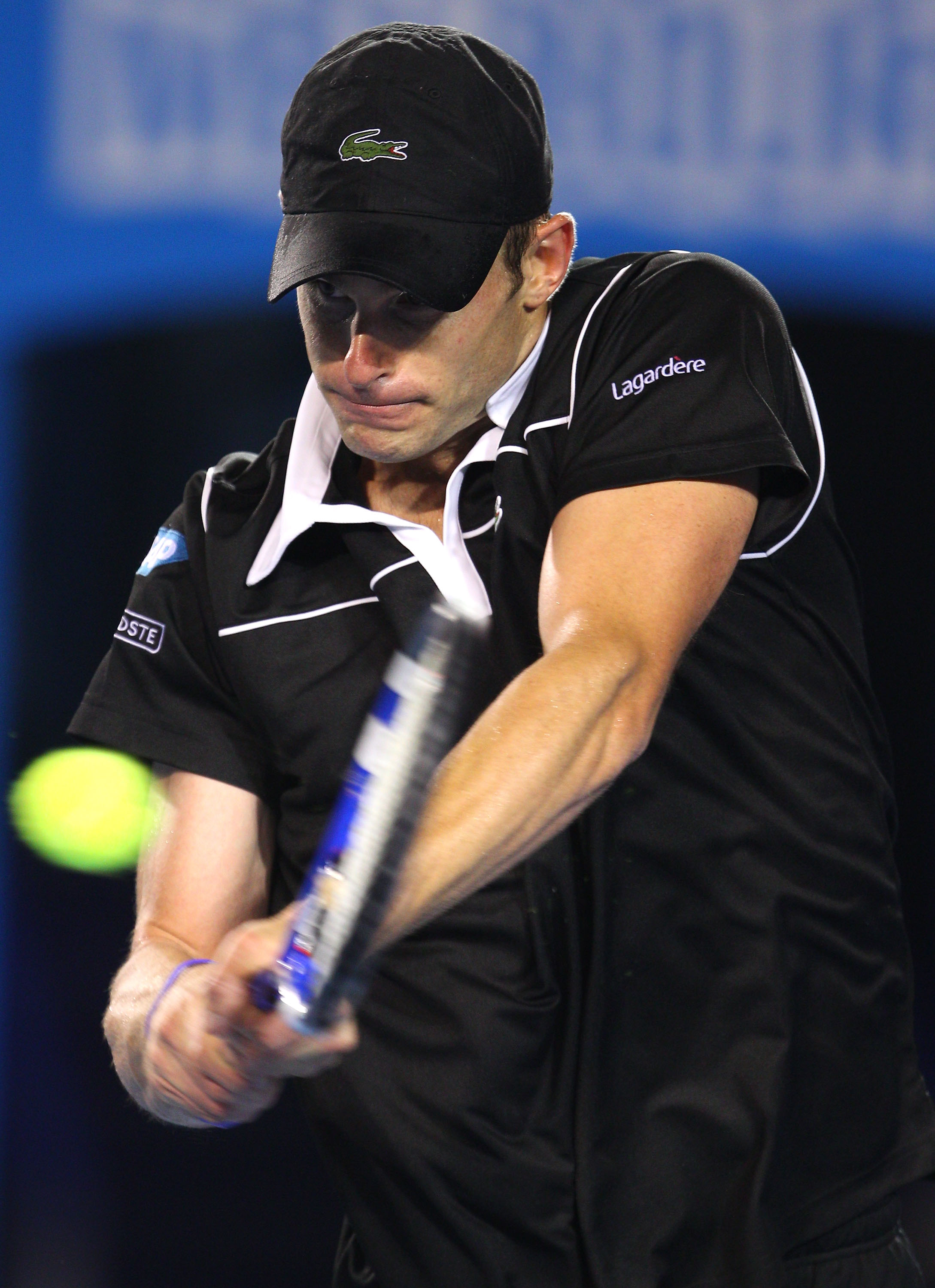 MELBOURNE, AUSTRALIA - JANUARY 23:  Andy Roddick of the United States of America plays a backhand in his fourth round match against Stanislas Wawrinka of Switzerland during day seven of the 2011 Australian Open at Melbourne Park on January 23, 2011 in Mel