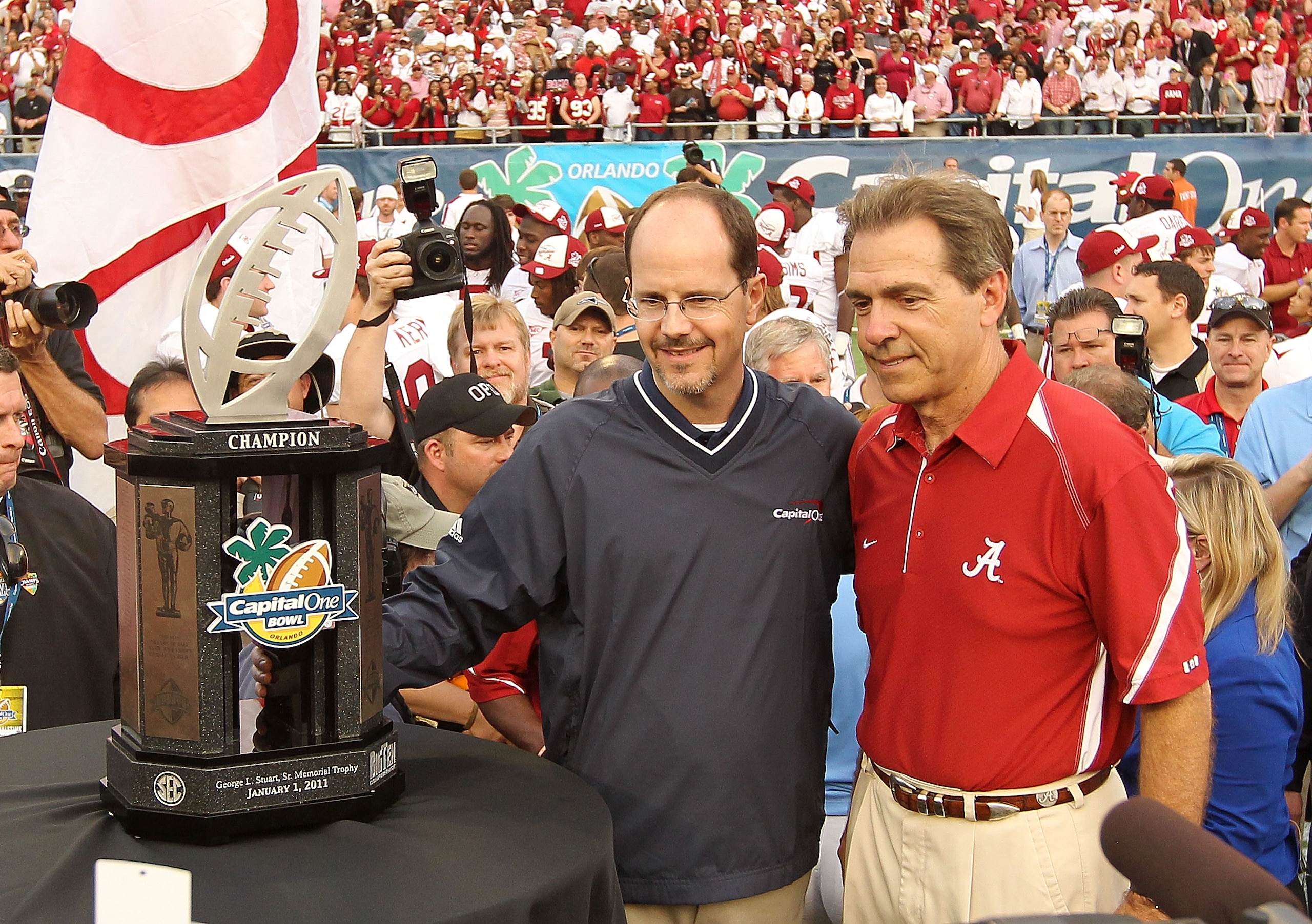 ORLANDO, FL - JANUARY 01:  Alabama Crimson Tide Head Coach Nick Saban is presented the trophy for winning the Capitol One Bowl against the Michigan State Spartans at the Florida Citrus Bowl on January 1, 2011 in Orlando, Florida.  (Photo by Mike Ehrmann/G