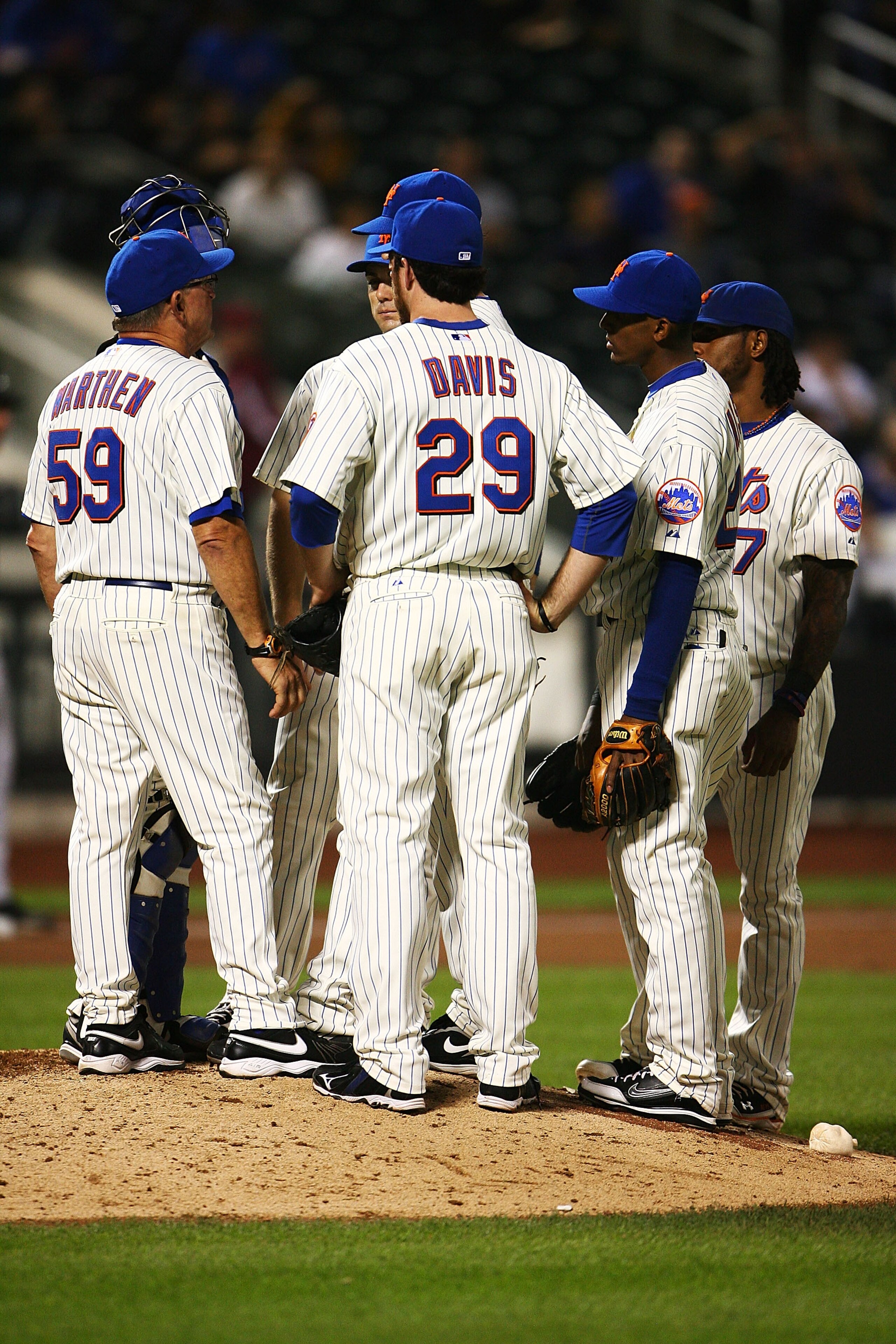 NEW YORK - SEPTEMBER 30: The New York Mets hold a team meeting on the mound in the ninth inning during their game against the Milwaukee Brewers on September 30, 2010 at Citi Field in the Flushing neighborhood of the Queens borough of New York City.  The B