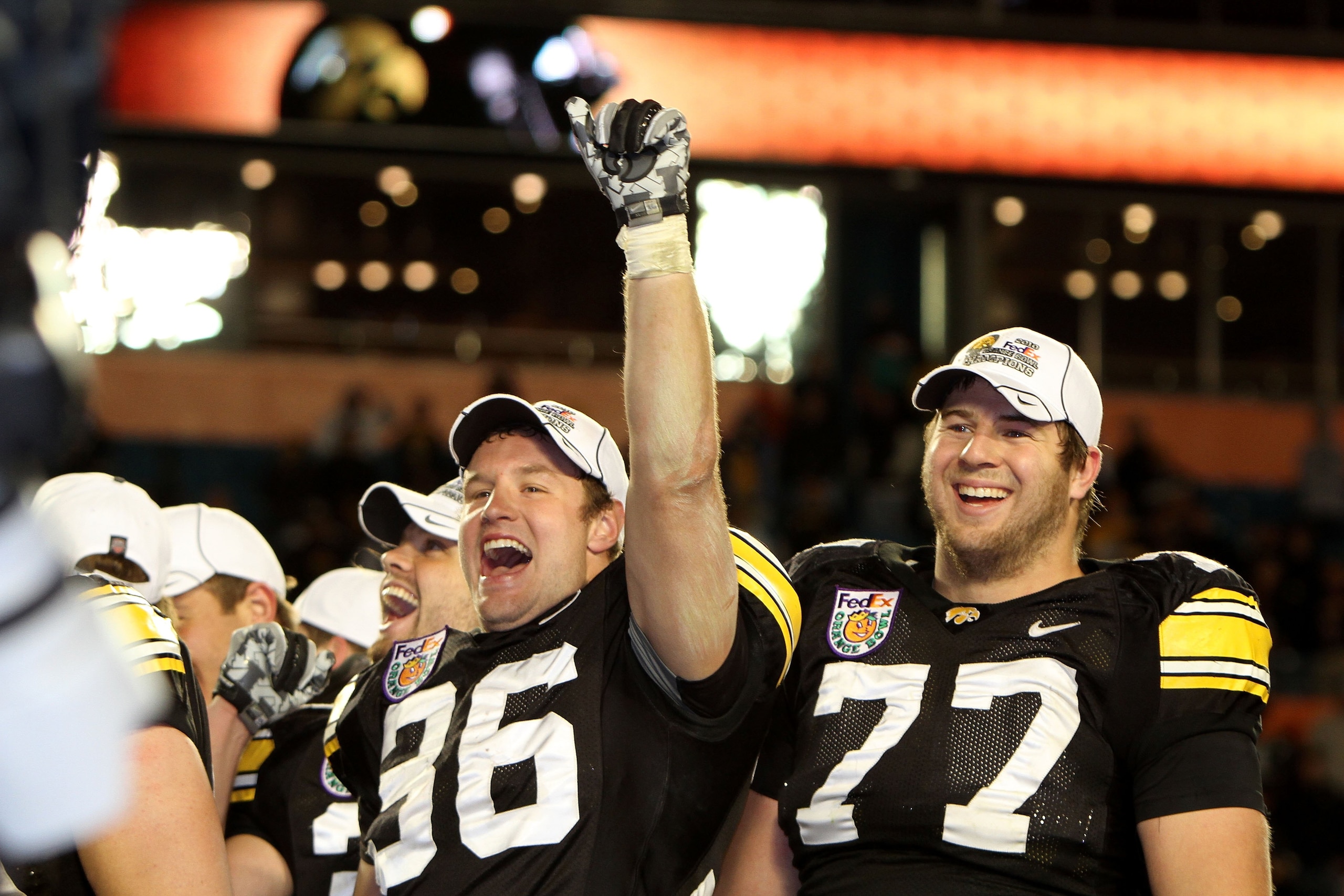 MIAMI GARDENS, FL - JANUARY 05:  (L-R) Trey Stross #86 and Riley Reiff #77 of the Iowa Hawkeyes celebrate after Iowa won 24-14  against the Georgia Tech Yellow Jackets during the FedEx Orange Bowl at Land Shark Stadium on January 5, 2010 in Miami Gardens,
