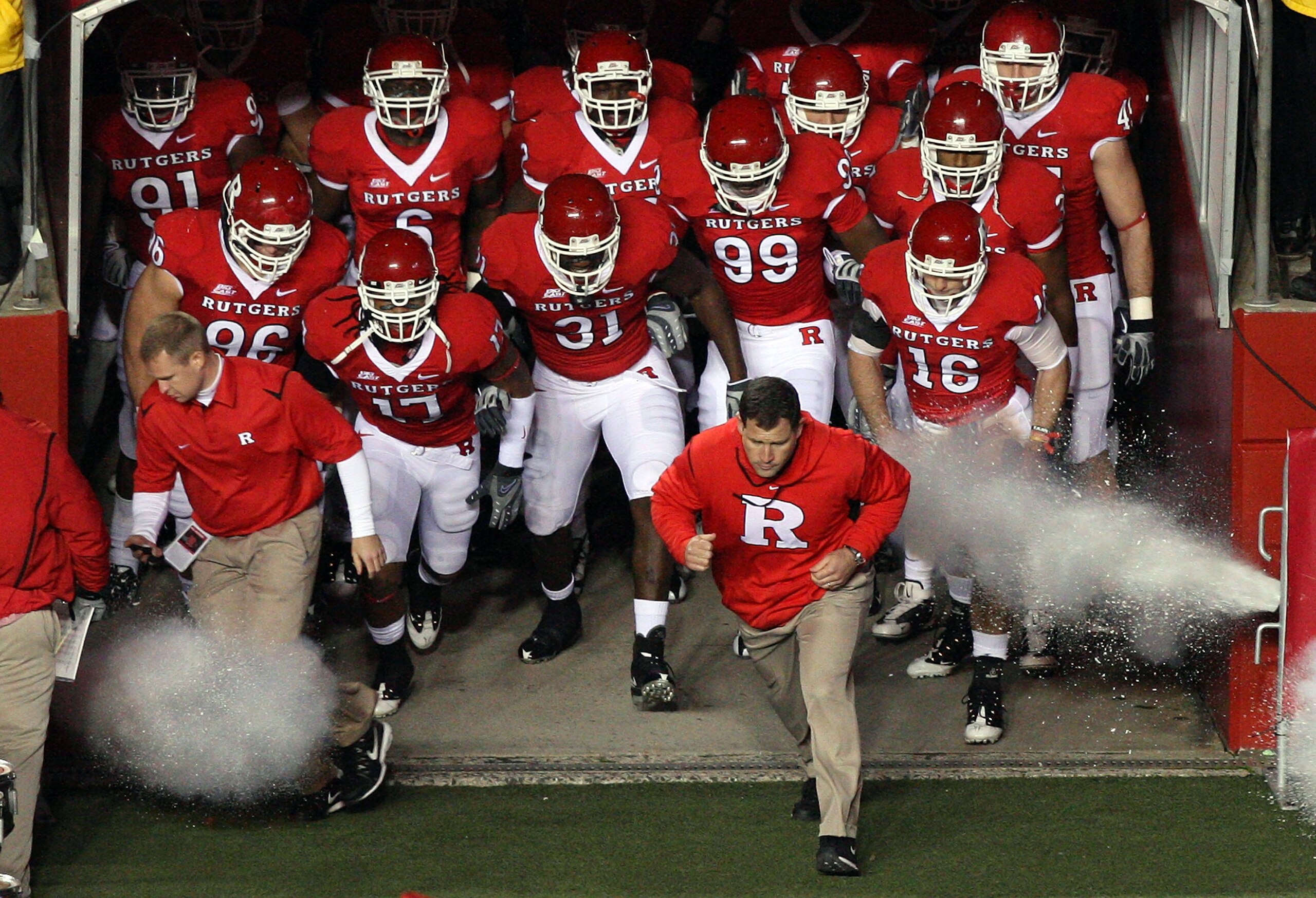 PISCATAWAY, NJ - NOVEMBER 12:  Head coach Greg Schiano of the Rutgers Scarlet Knights leads his team on the field to play against the South Florida Bulls at Rutgers Stadium on November 12, 2009 in Piscataway, New Jersey.  (Photo by Jim McIsaac/Getty Image