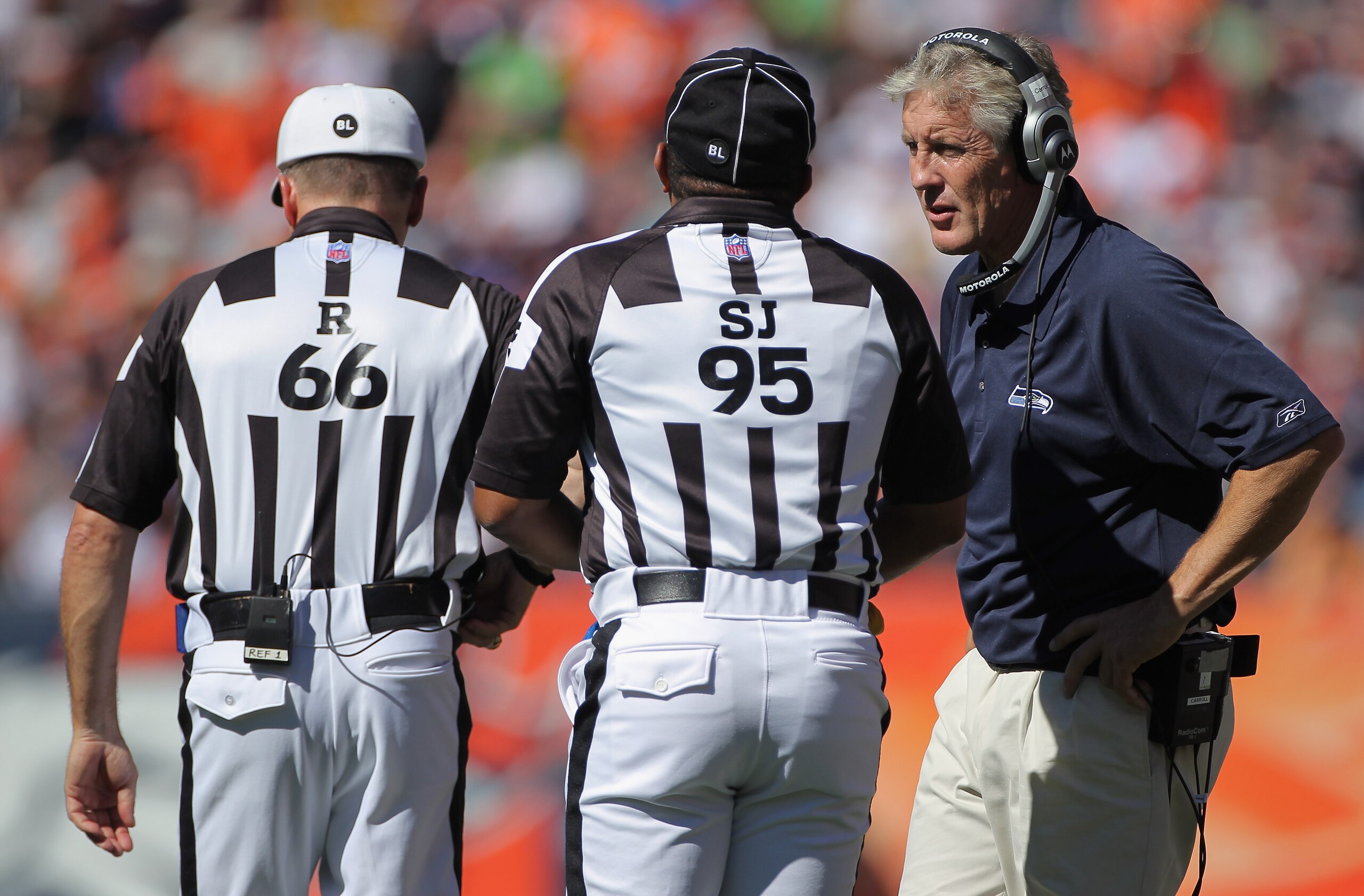 DENVER - SEPTEMBER 19:  Head coach Pete Carroll of the Seattle Seahawks questions a call with side judge James Coleman and referee Walt Anderson against the Denver Broncos at INVESCO Field at Mile High on September 19, 2010 in Denver, Colorado. The Bronco