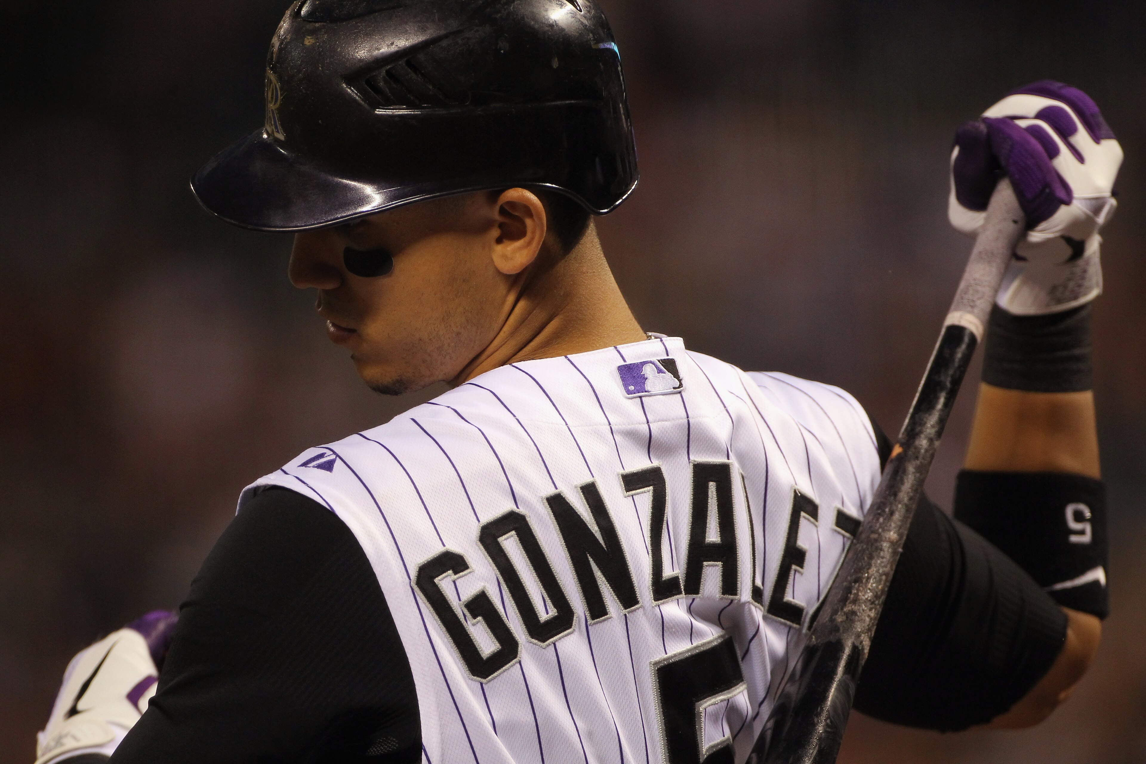 DENVER - SEPTEMBER 27:  Carlos Gonzalez #5 of the Colorado Rockies warms up on deck as he prepares to take an at bat against the Los Angeles Dodgers at Coors Field on September 25, 2010 in Denver, Colorado. The Dodgers defeated the Rockies 3-1.  (Photo by