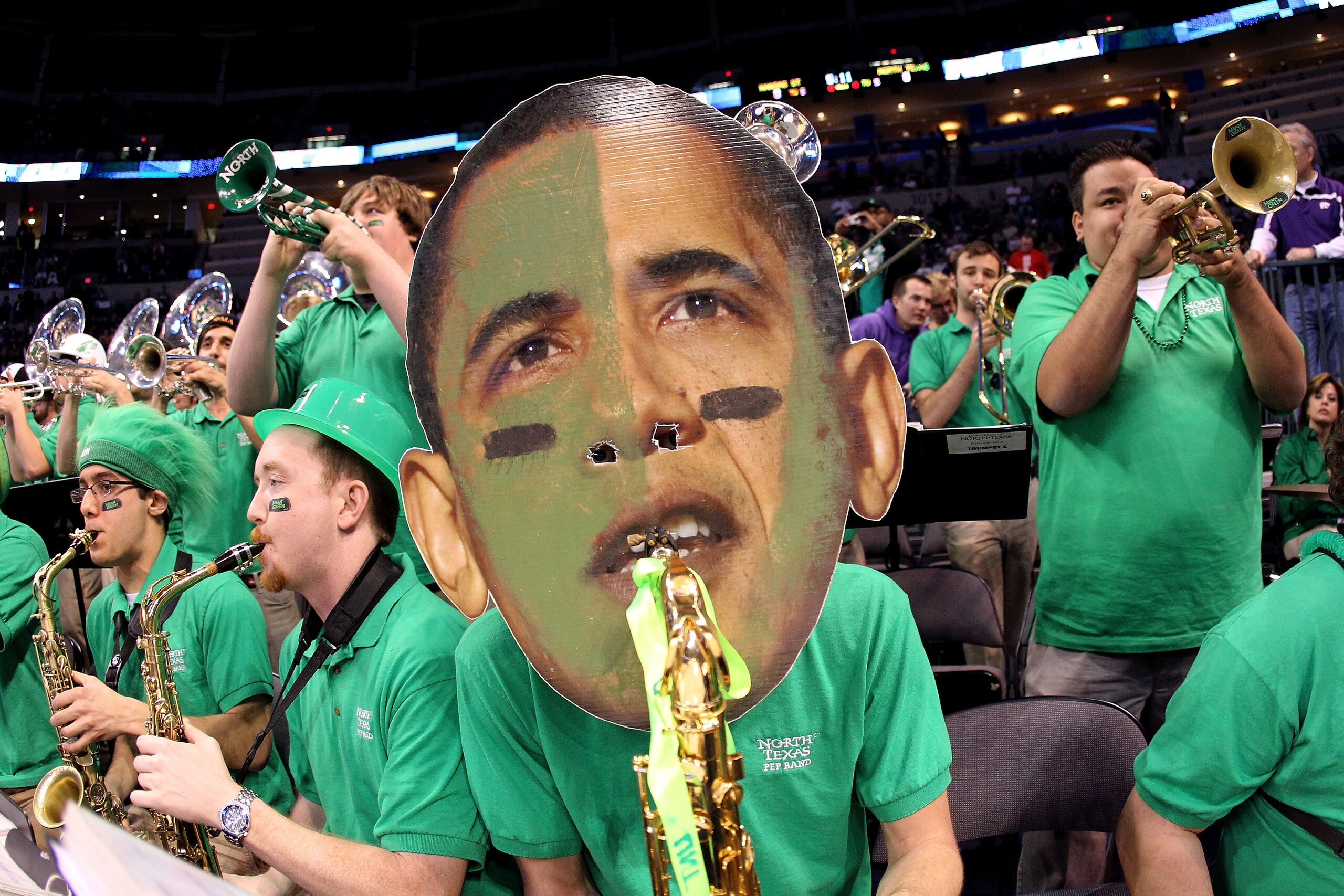 OKLAHOMA CITY - MARCH 18:  A member of the North Texas Mean Green wears a mask with the likeness of U.S. President Barack Obama as they perform against the Kansas State Wildcats during the first round of the 2010 NCAA men's basketball tournament at Ford C