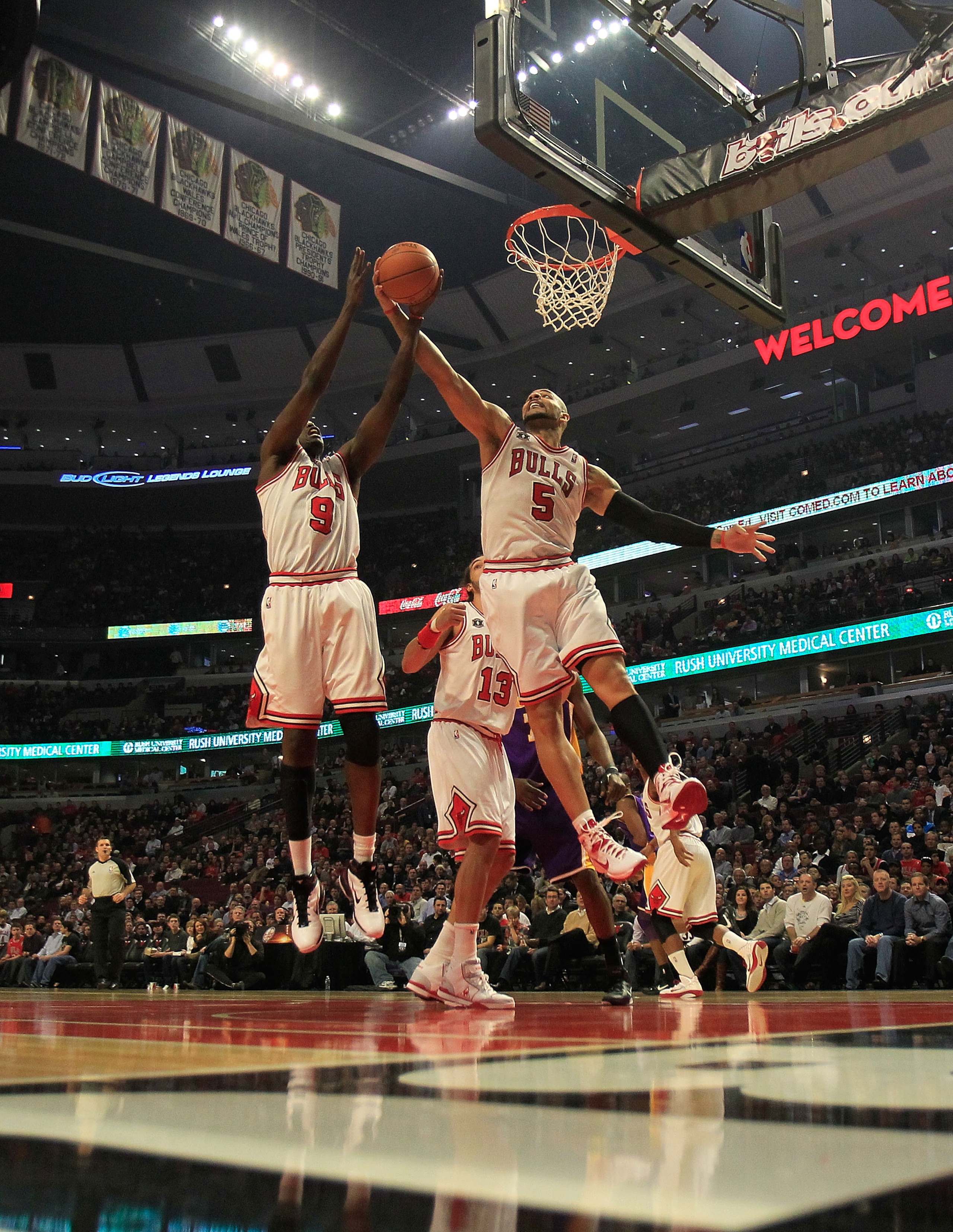 CHICAGO, IL - DECEMBER 10: Loul Deng #9 and Carlos Boozer #5 of the Chicago Bulls leap for a rebound against the Los Angeles Lakers at the United Center on December 10, 2010 in Chicago, Illinois. NOTE TO USER: User expressly acknowledges and agrees that,