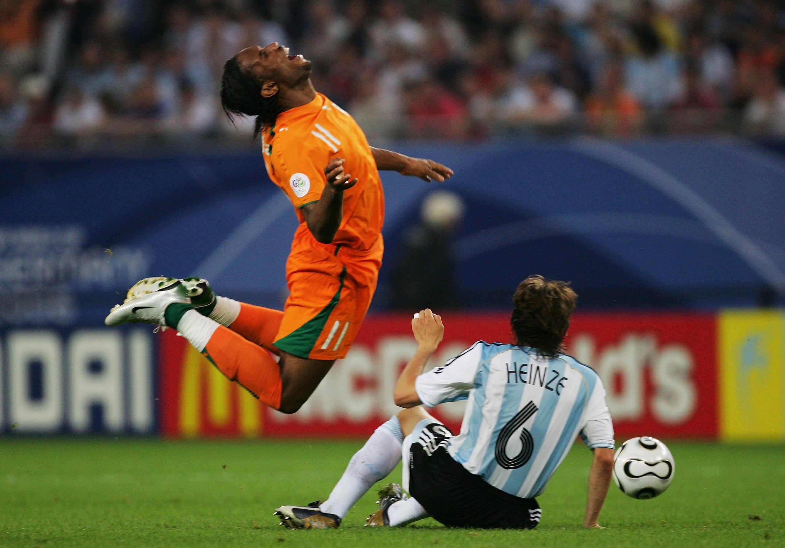 HAMBURG, GERMANY - JUNE 10: Didier Drogba of Ivory Coast is tackled by Gabriel Heinze of Argentina during the FIFA World Cup Germany 2006 Group C match between Argentina and Ivory Coast played at the Stadium Hamburg on June 10, 2006 in Hamburg, Germany. (
