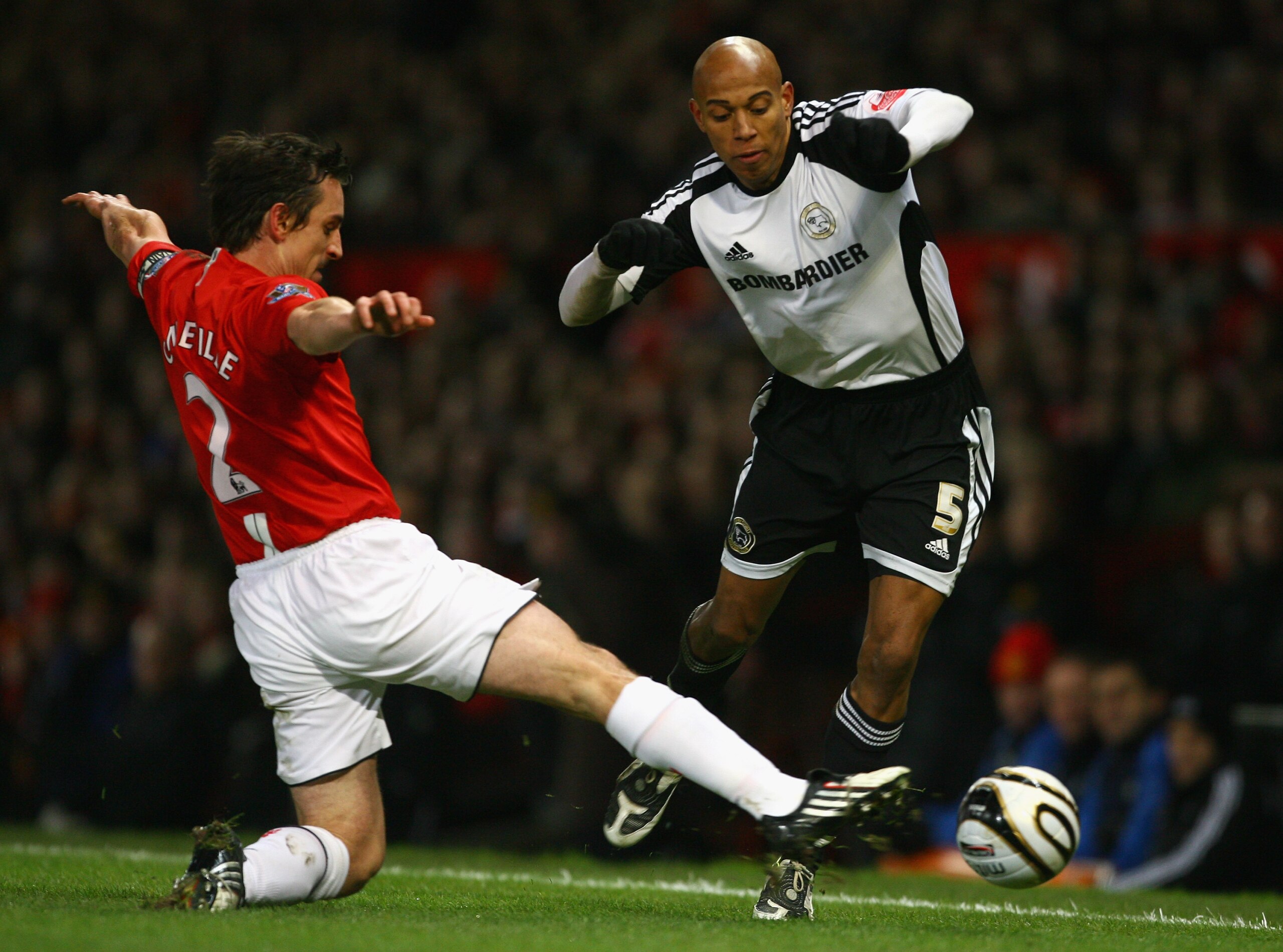 MANCHESTER, UNITED KINGDOM - JANUARY 20:  Gary Neville of Manchester United tackles Jordan Stewart of Derby County during the Carling Cup Semi Final 2nd Leg match between Manchester United and Derby County at Old Trafford on January 20, 2009 in Manchester