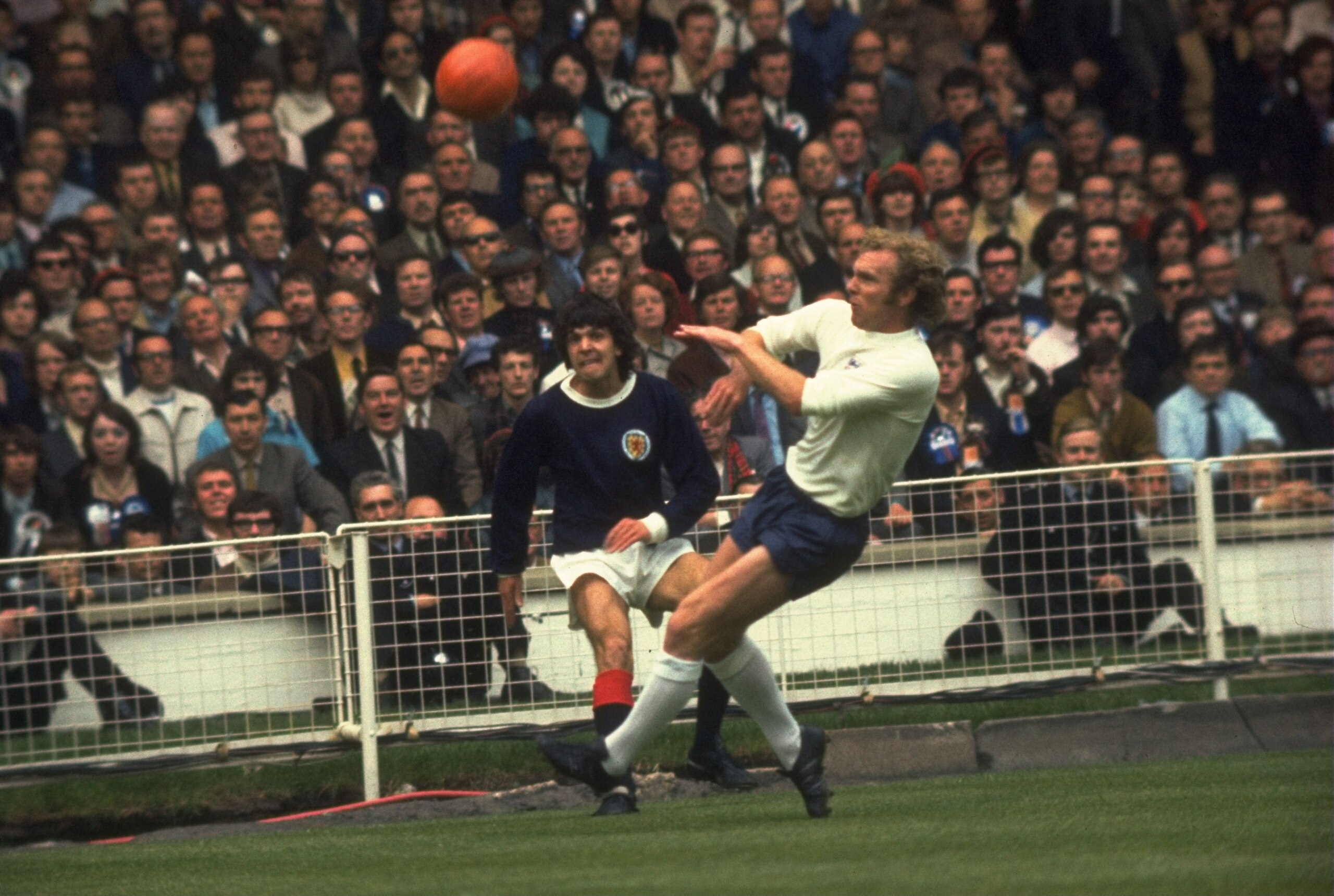 22 May 1971:  Peter Cormack of Scotland (left) and Bobby Moore (right) of England both challenge for the ball during the match at Hampden Park in Glasgow, Scotland. England won the match 3-1. \ Mandatory Credit: Allsport UK /Allsport