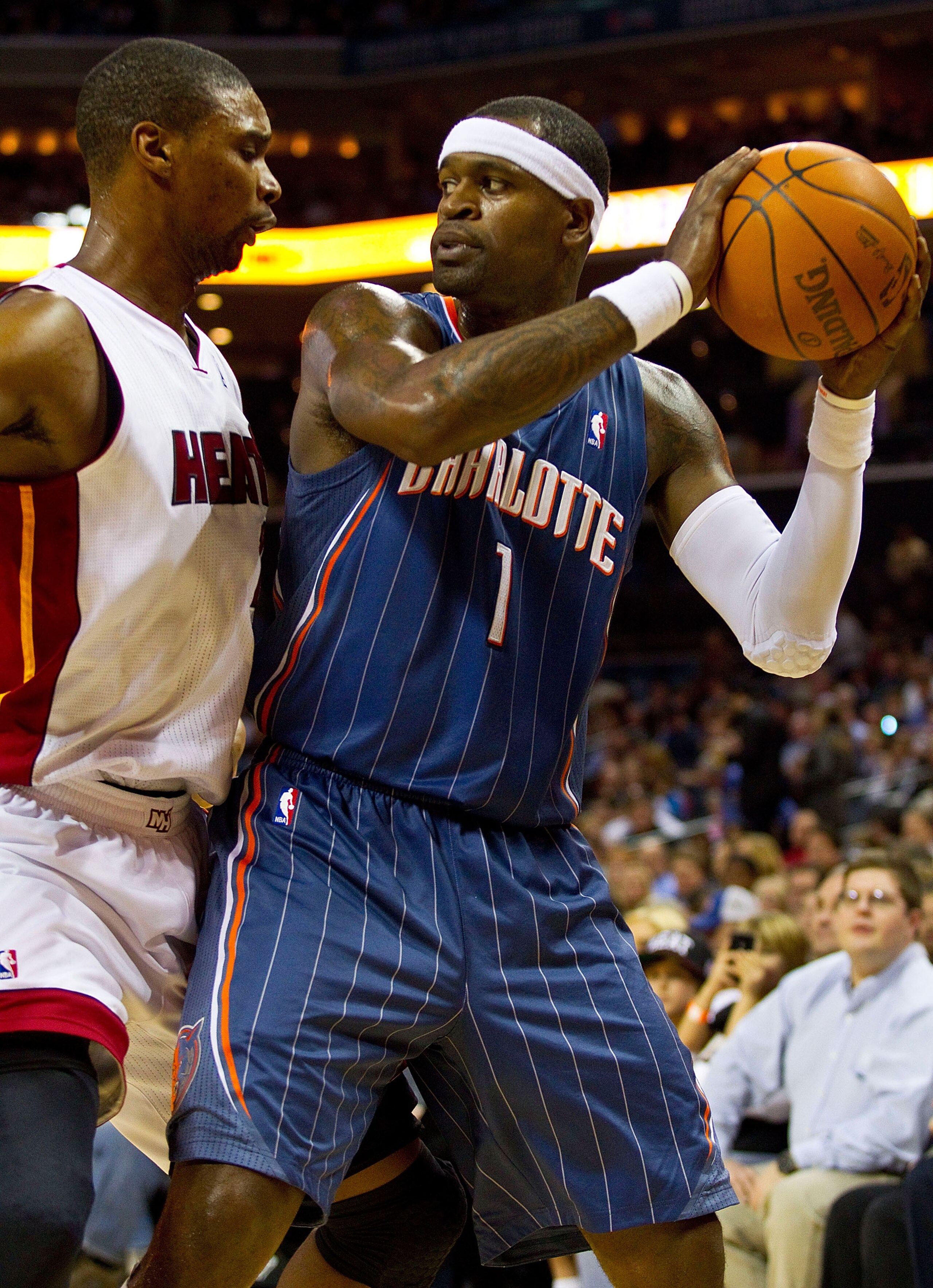 CHARLOTTE, NC - FEBRUARY 04:  Stephen Jackson #1 of the Charlotte Bobcats is guarded by Chris Bosh #1 of the Miami Heat at the Time Warner Cable Arena on February 4, 2011 in Charlotte, North Carolina.  The Heat defeated the Bobcats 109-97.  NOTE TO USER: