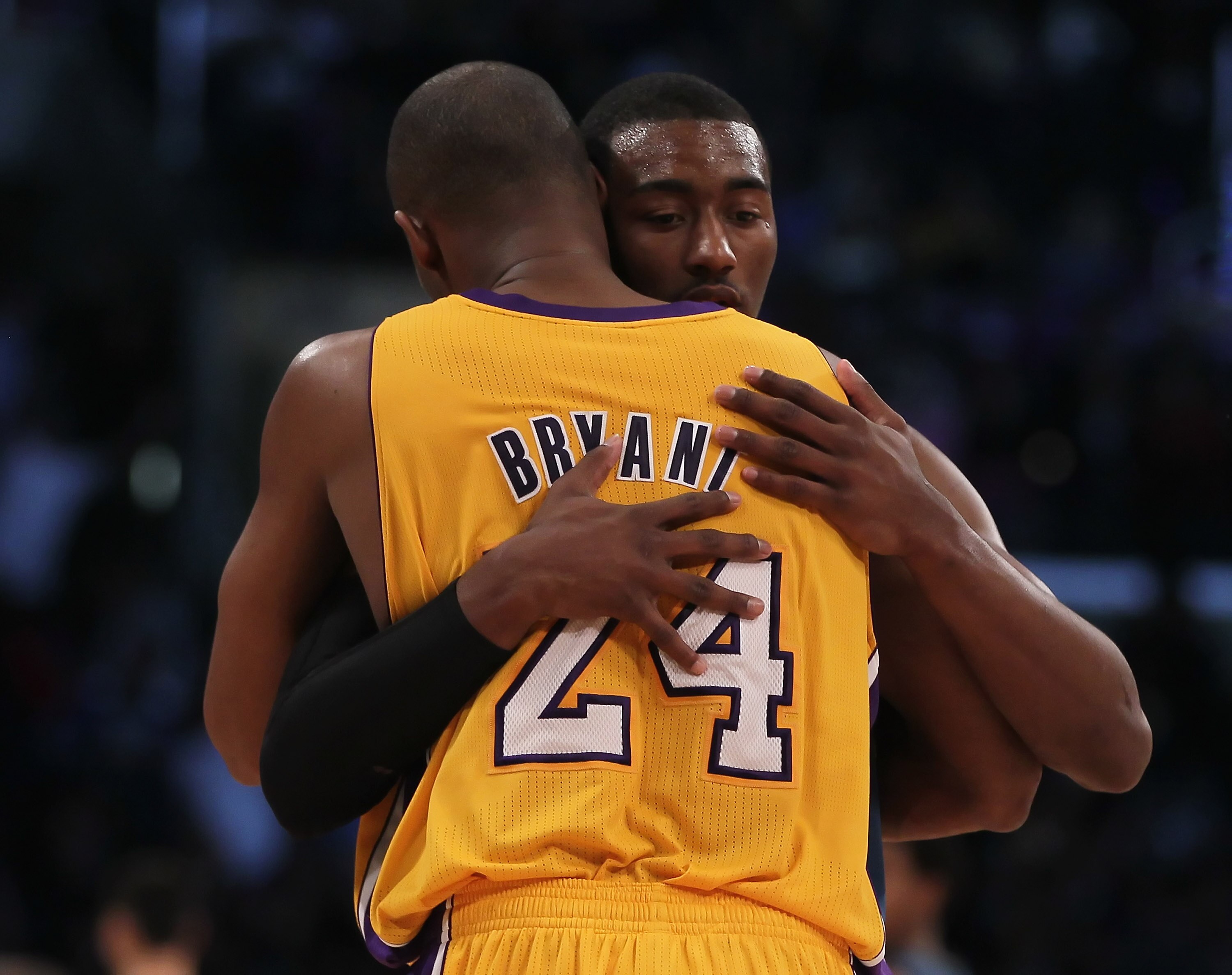 LOS ANGELES, CA - DECEMBER 07:  Kobe Bryant #24 of the Los Angeles Lakers and John Wall #2 of the Washington Wizards hug at the conclusion of the game at Staples Center on December 7, 2010 in Los Angeles, California. The Lakers defeated the Wizards 115-10