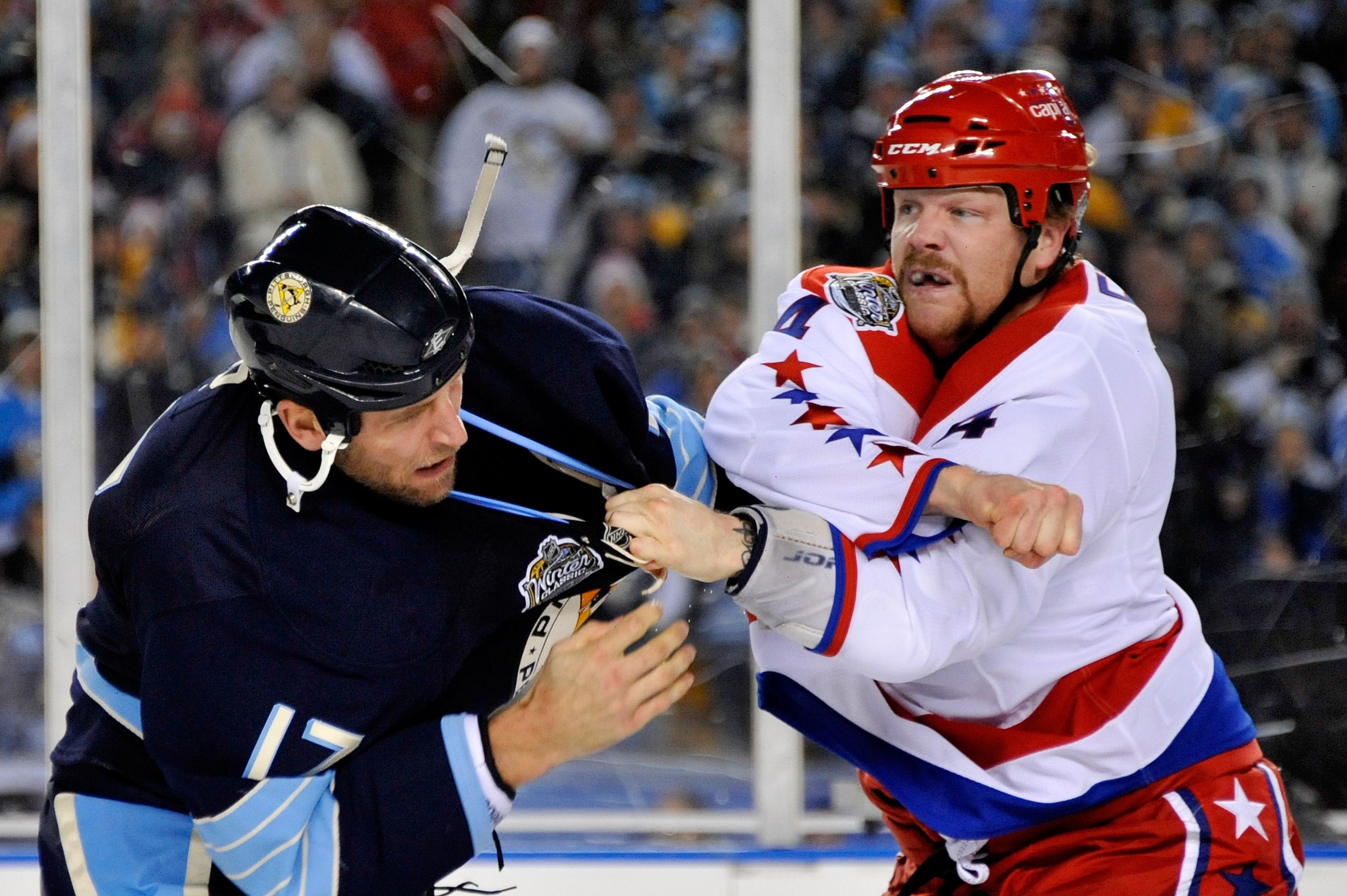 PITTSBURGH, PA - JANUARY 01:  John Erskine #4 of the Washington Capitals and Michael Rupp #17 of the Pittsburgh Penguins fight during the 2011 NHL Bridgestone Winter Classic at Heinz Field on January 1, 2011 in Pittsburgh, Pennsylvania.  (Photo by Jamie S