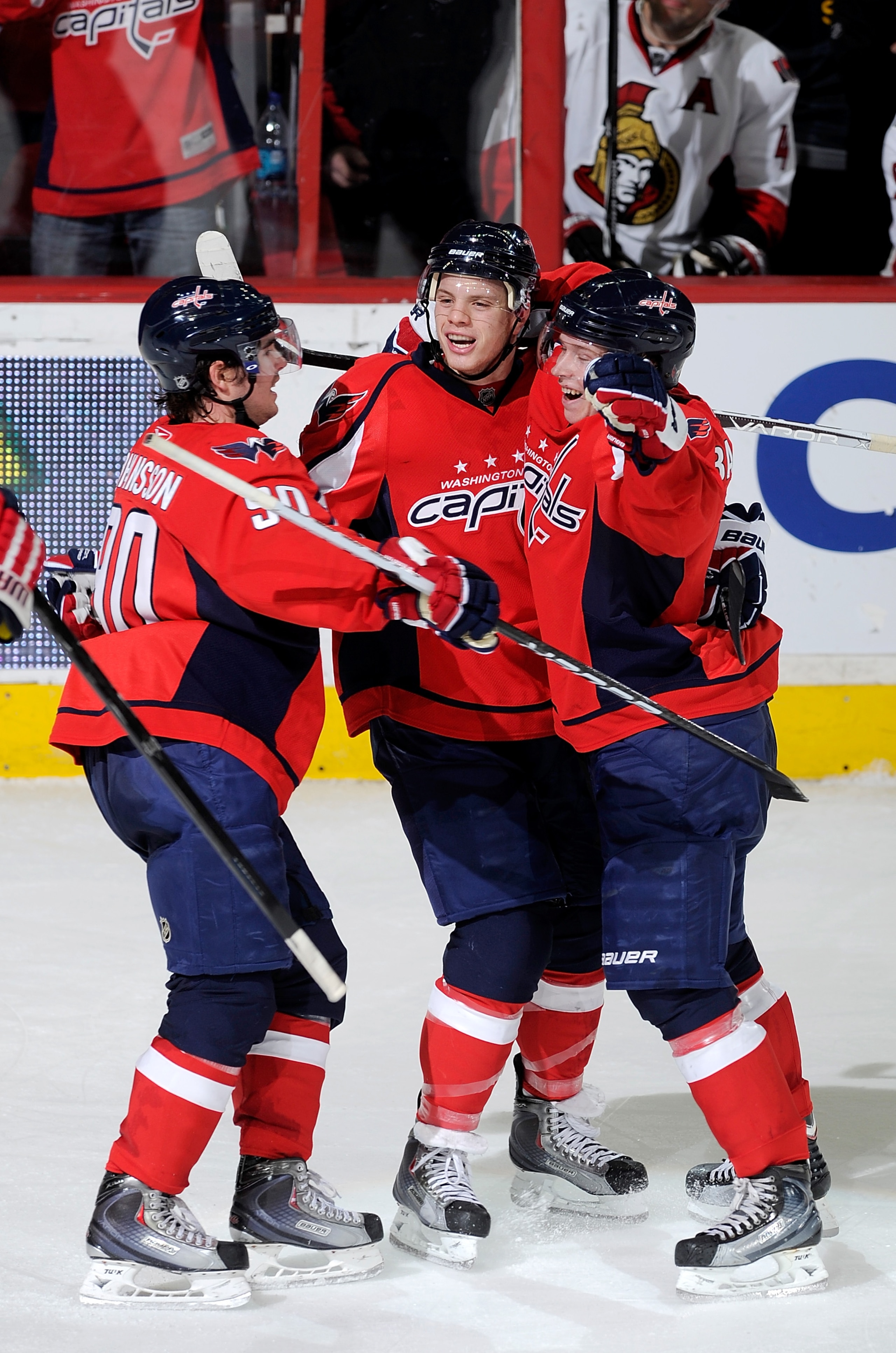 WASHINGTON, DC - JANUARY 16:  John Carlson #74 of the Washington Capitals celebrates with Marcus Johansson #90 and Nicklas Backstrom #19 after scoring the game winning goal against the Ottawa Senators at the Verizon Center on January 16, 2011 in Washingto