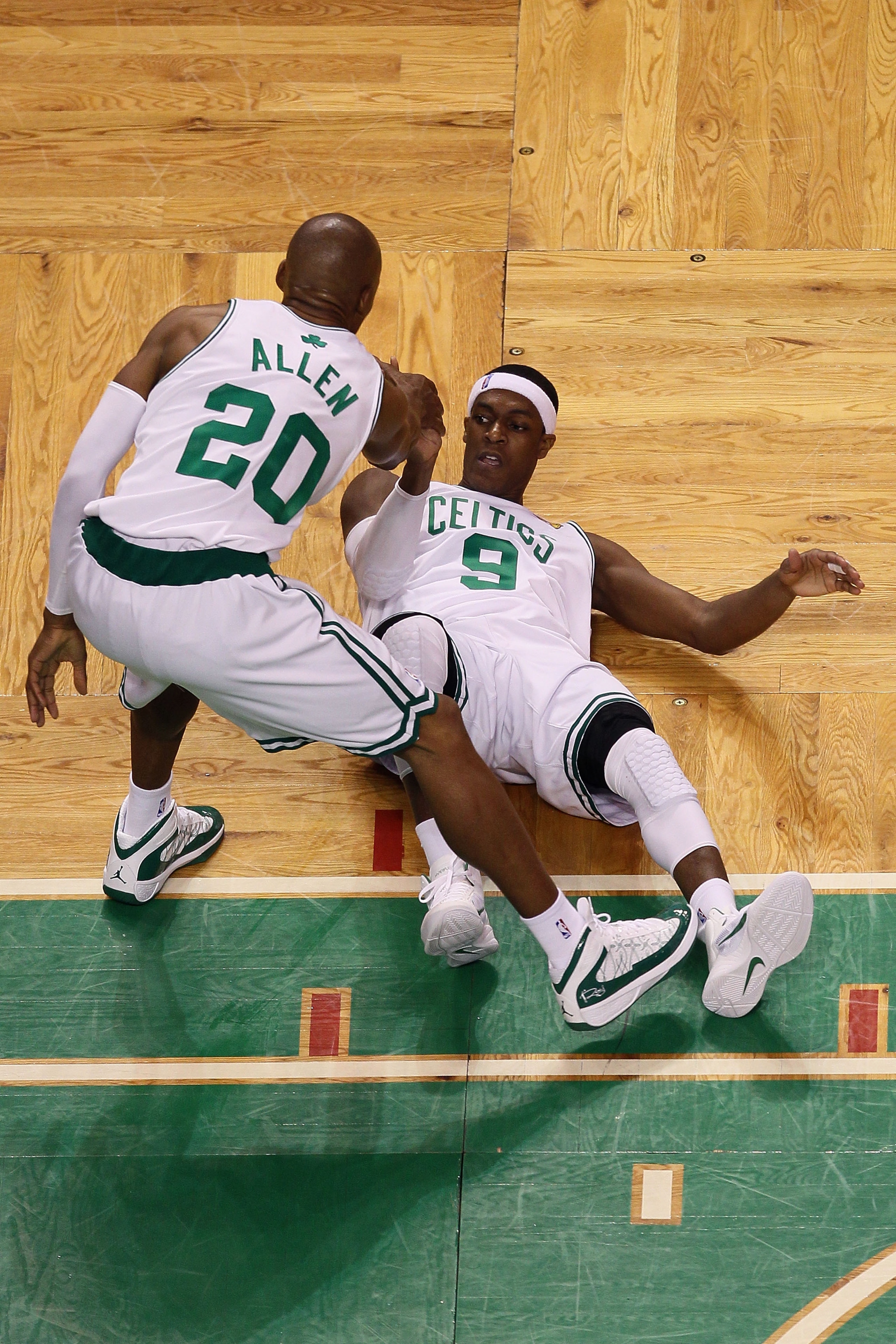 BOSTON - JUNE 13:  Rajon Rondo #9 of the Boston Celtics is helped up off the floor by teammate Ray Allen #20 during Game Five of the 2010 NBA Finals against the Los Angeles Lakers on June 13, 2010 at TD Garden in Boston, Massachusetts. NOTE TO USER: User